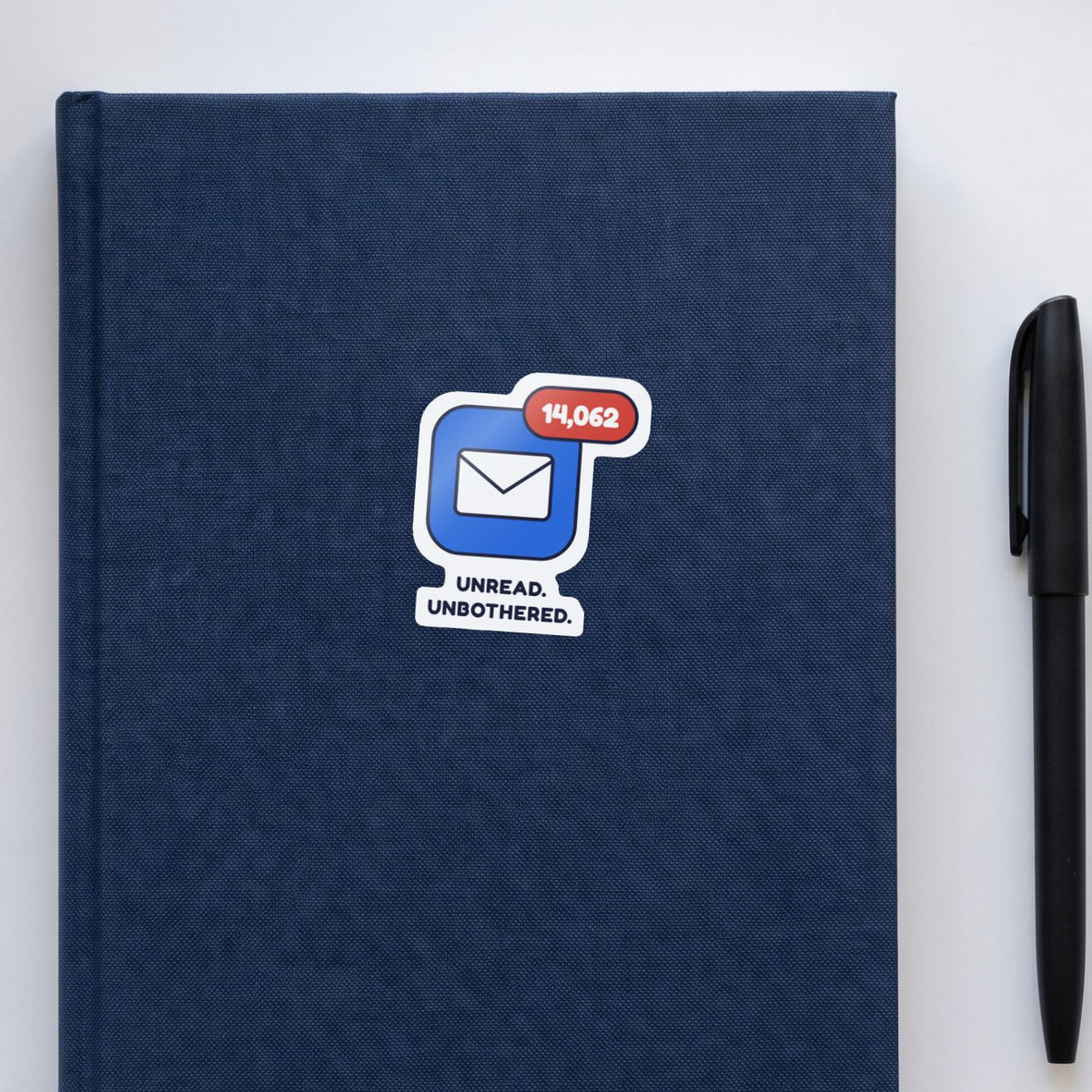 14,062 Unread sticker on a navy notebook