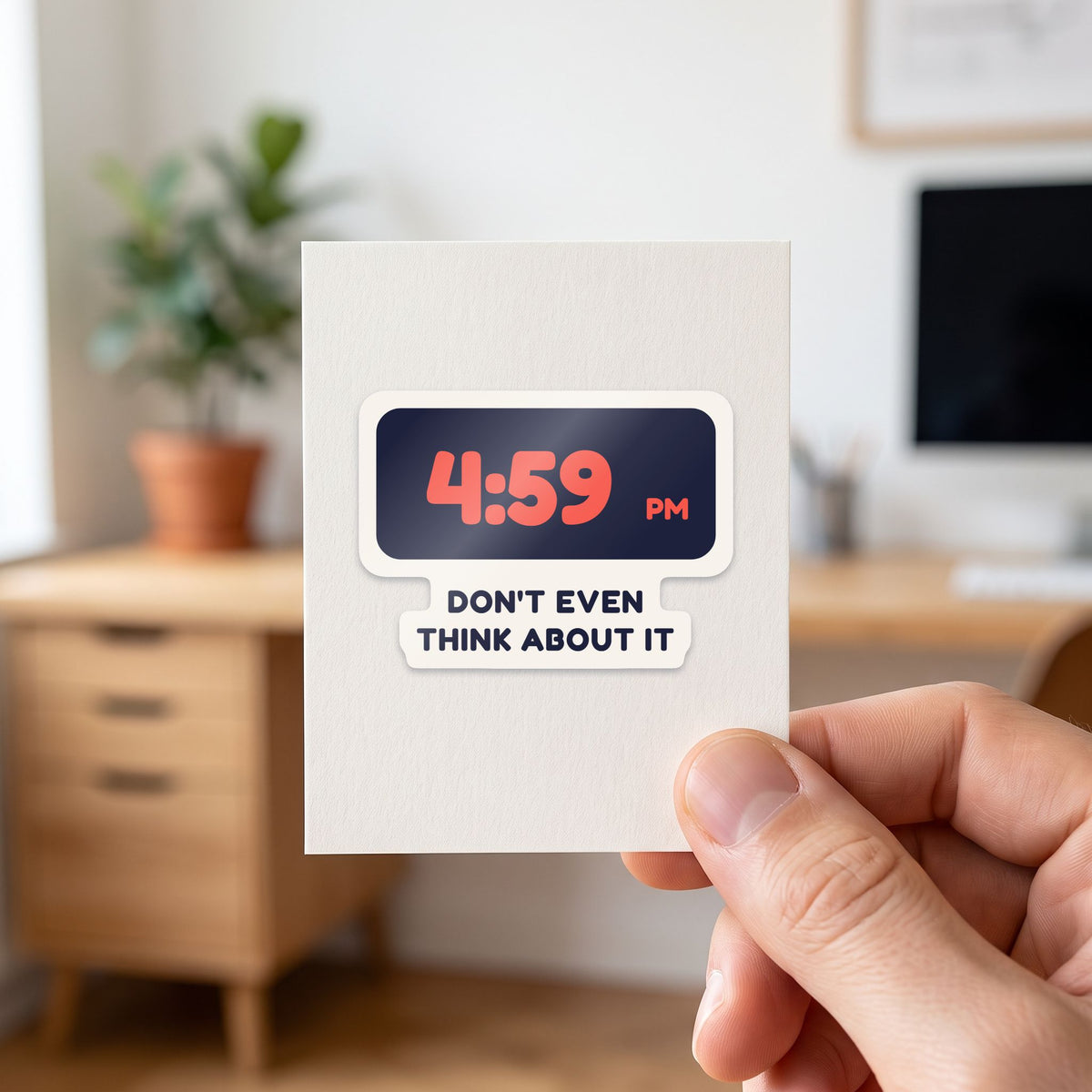 4:59 PM sticker held in a hand on its white backing card