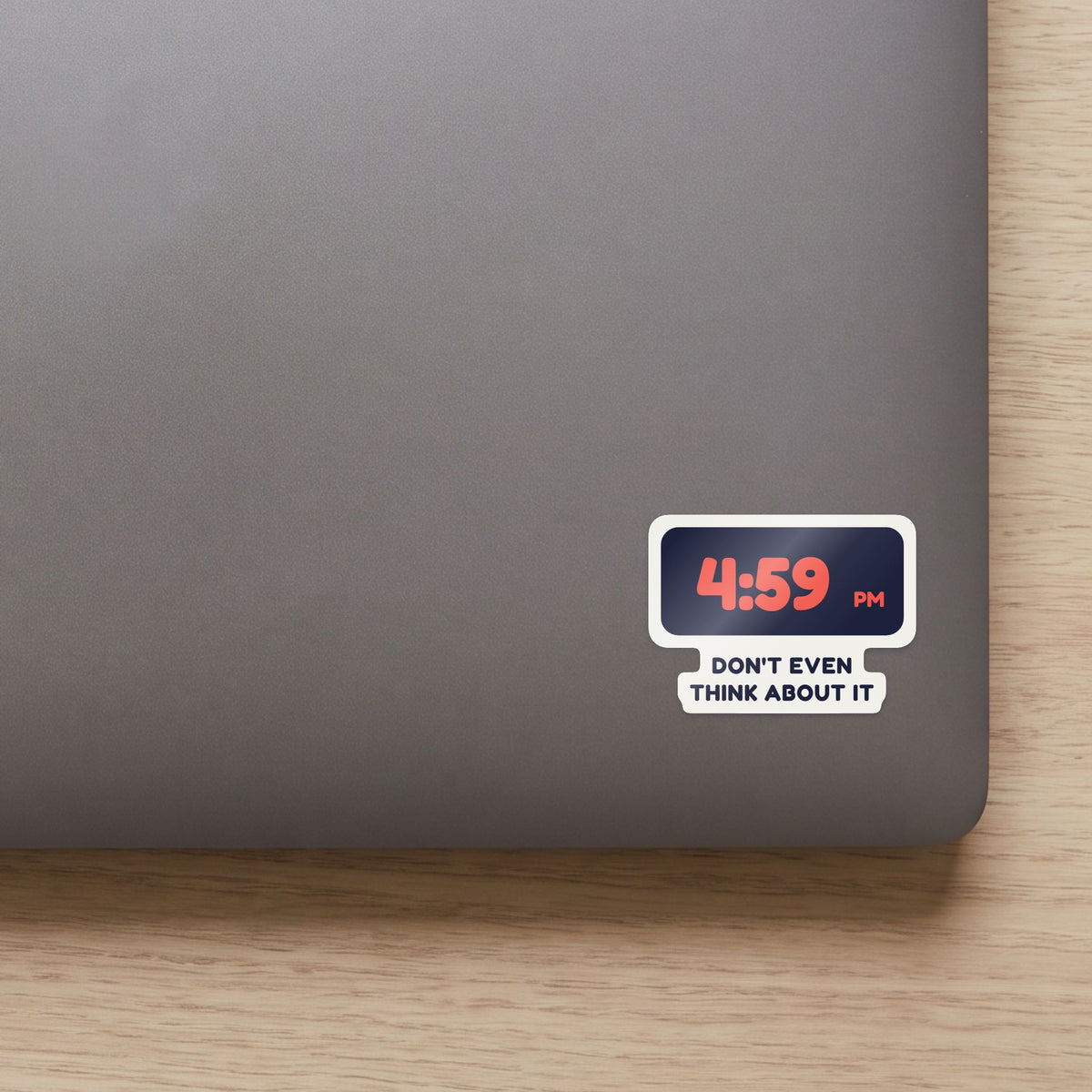 4:59 PM sticker on a navy notebook