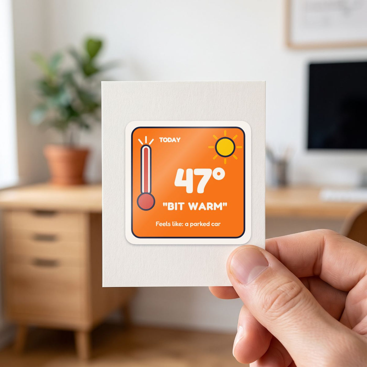 47 Degrees: Bit Warm sticker held in a hand on its white backing card