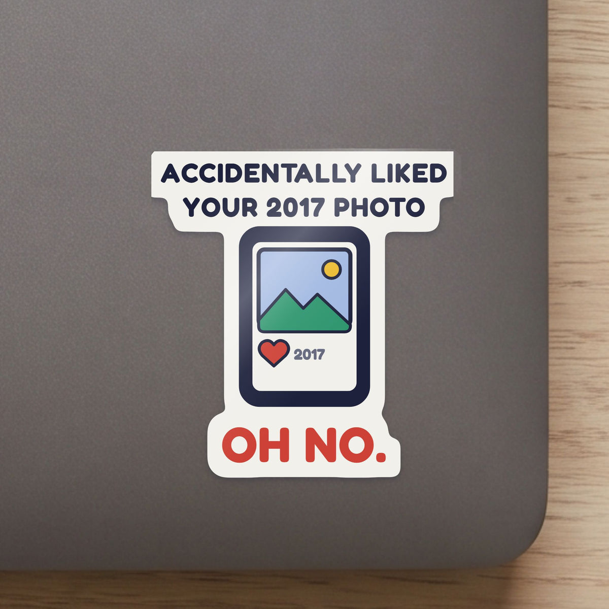 Accidentally Liked Your 2017 Photo sticker close up on a laptop lid, showing the gloss and the white cut edge