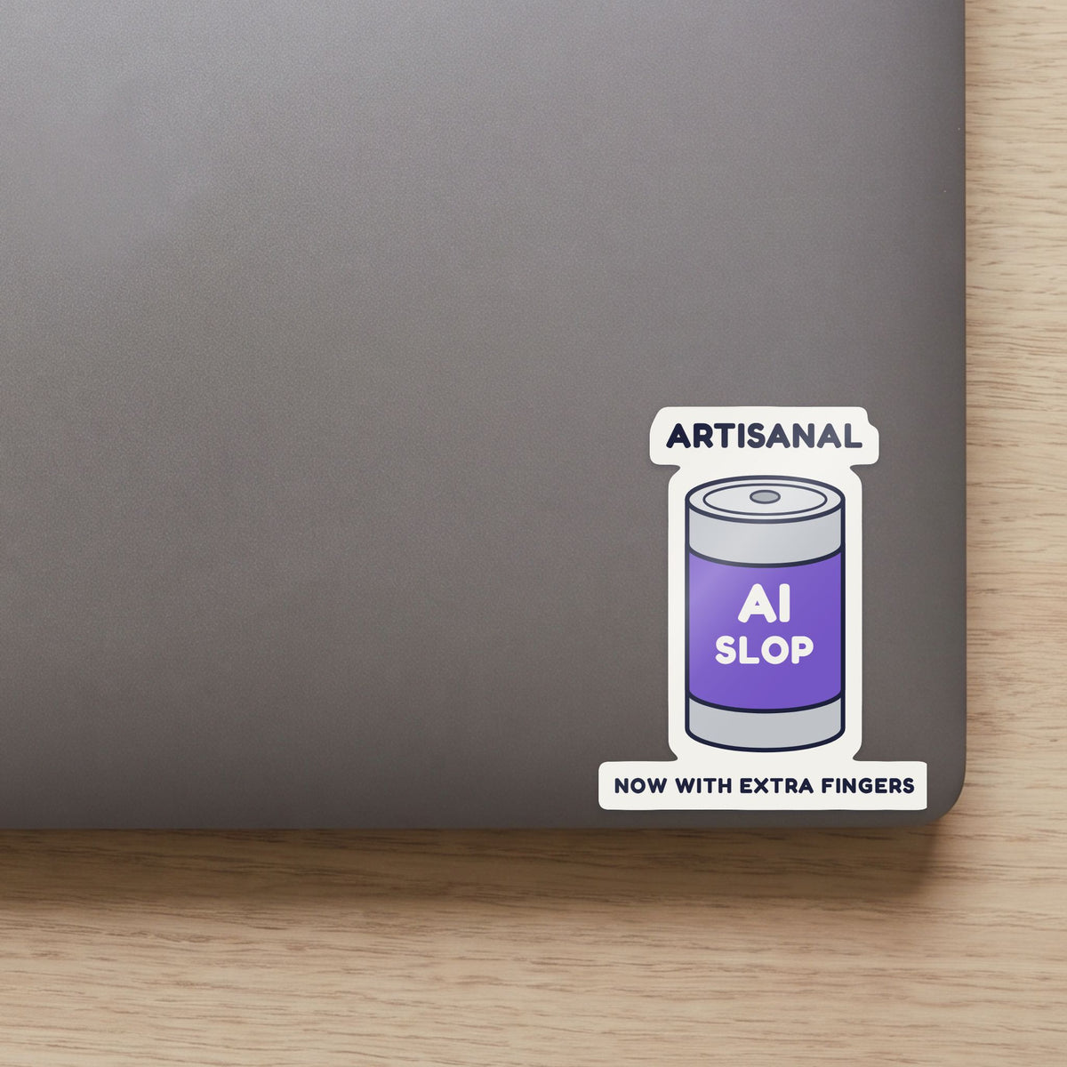 Artisanal AI Slop sticker on the lid of a grey laptop