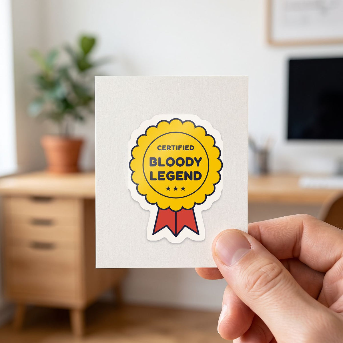 Certified Bloody Legend sticker held in a hand on its white backing card