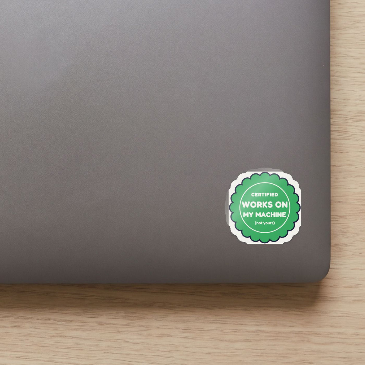Certified: Works on My Machine sticker on the lid of a grey laptop
