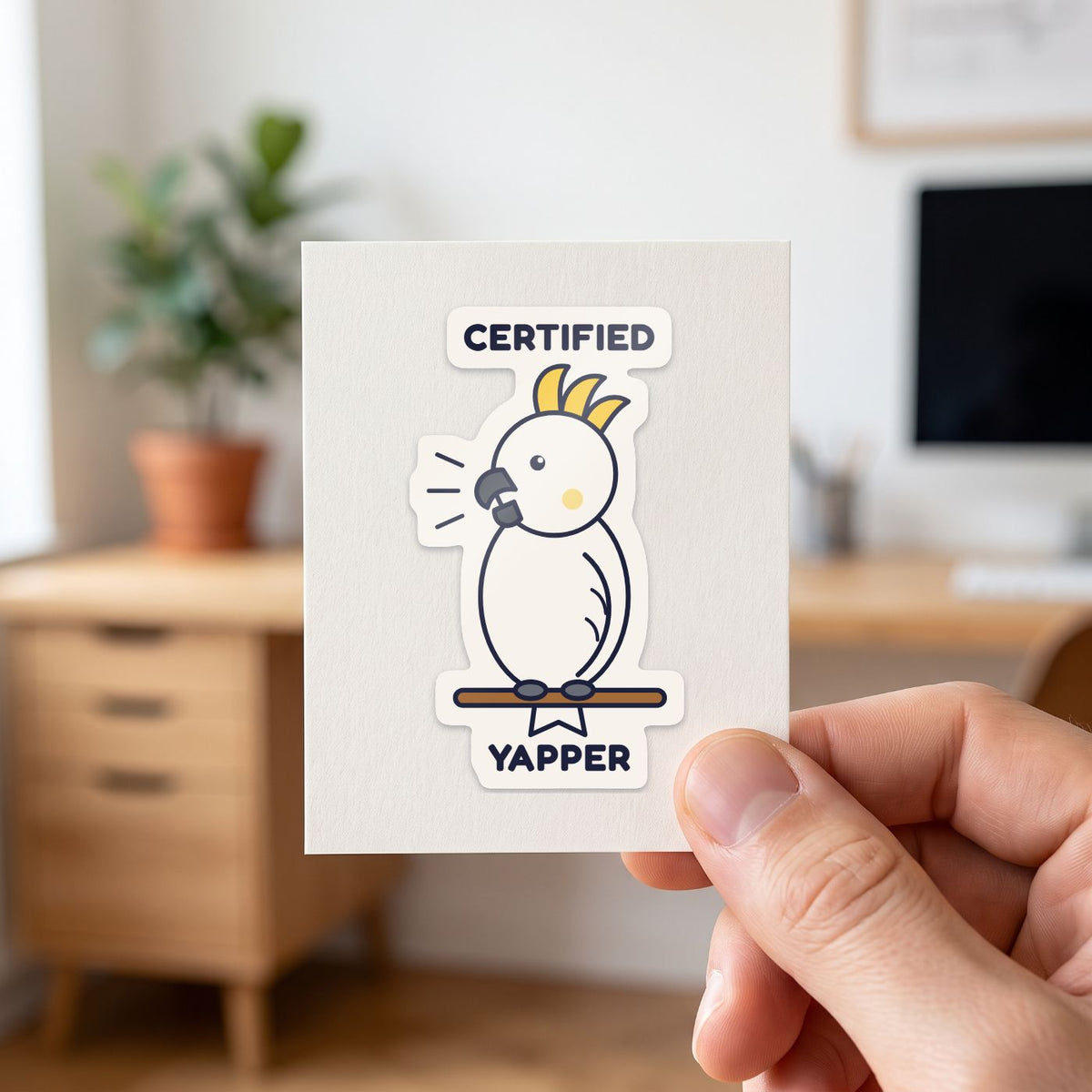 Certified Yapper sticker held in a hand on its white backing card