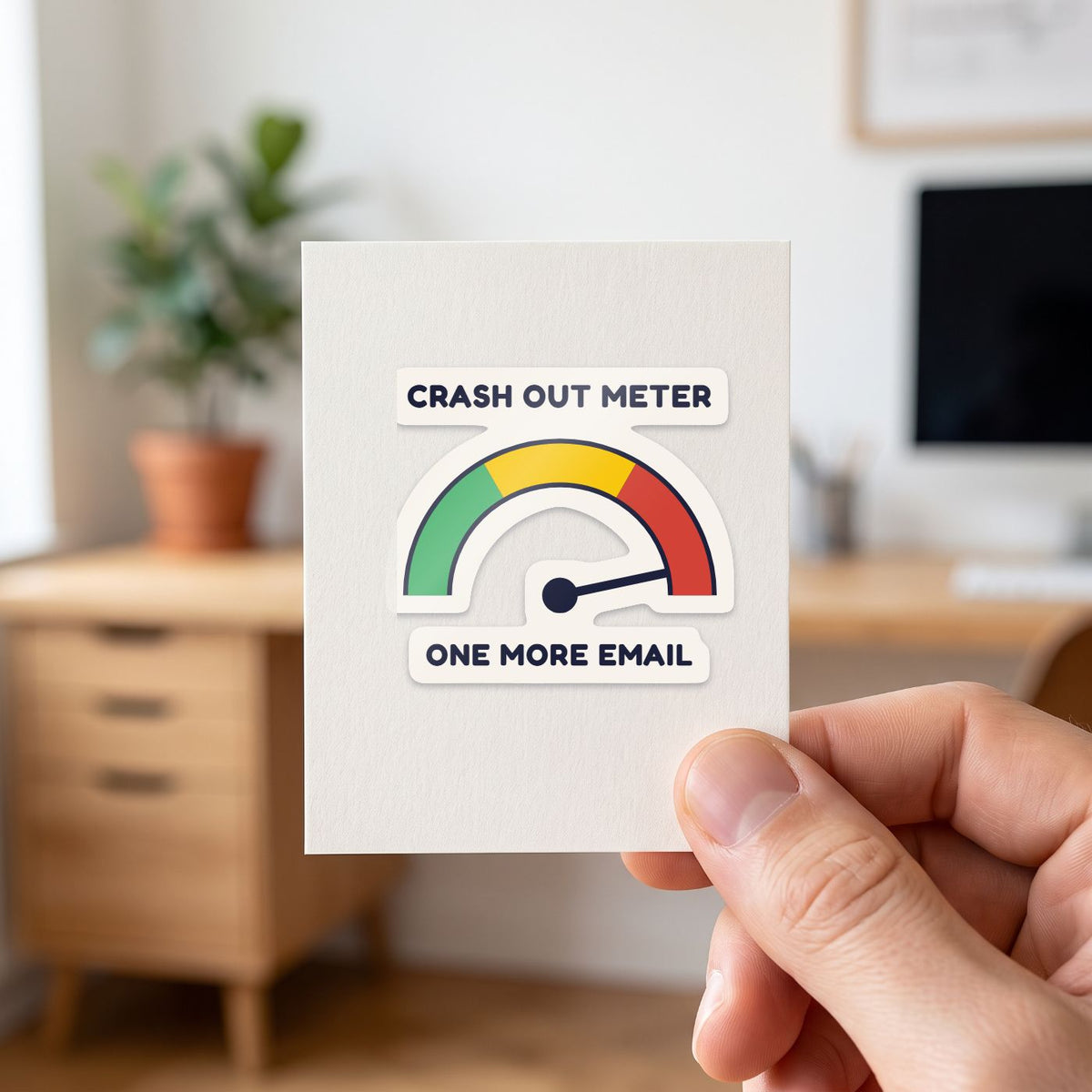 Crash Out Meter sticker held in a hand on its white backing card