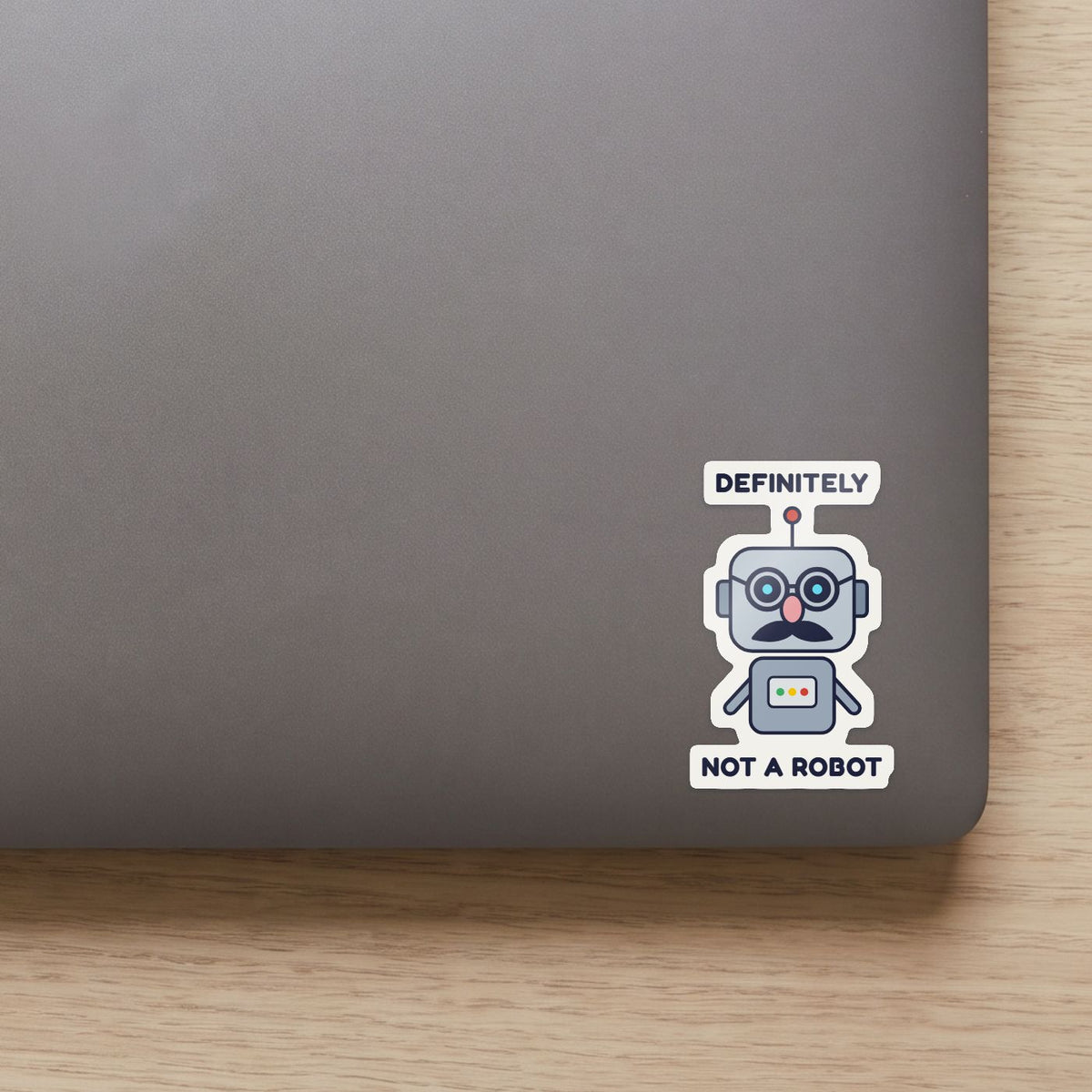 Definitely Not a Robot sticker on the lid of a grey laptop