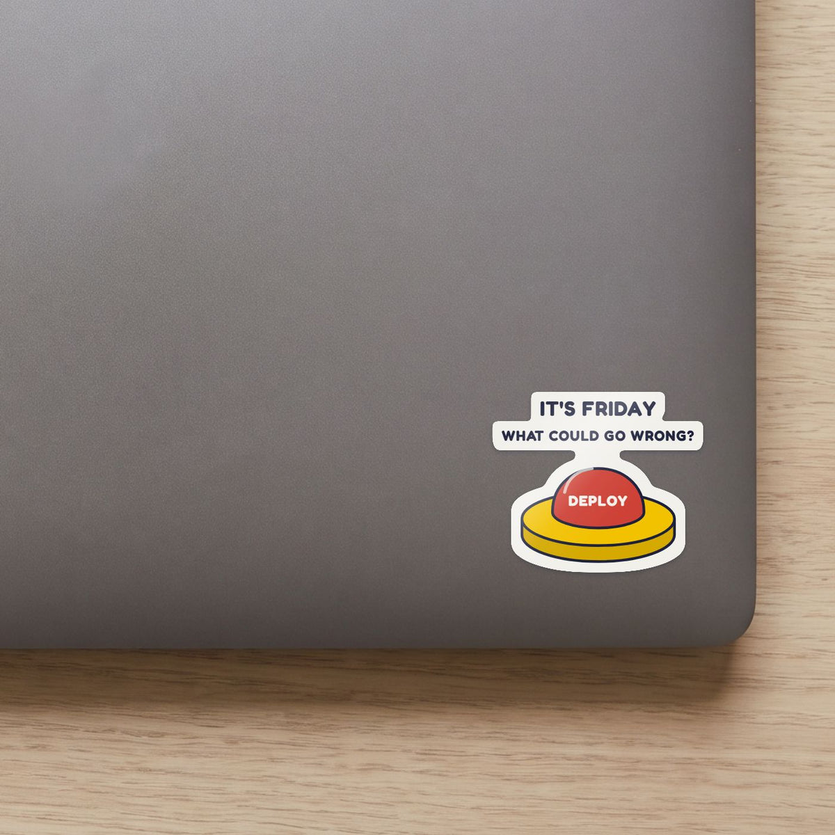 Deploy on Friday sticker on the lid of a grey laptop