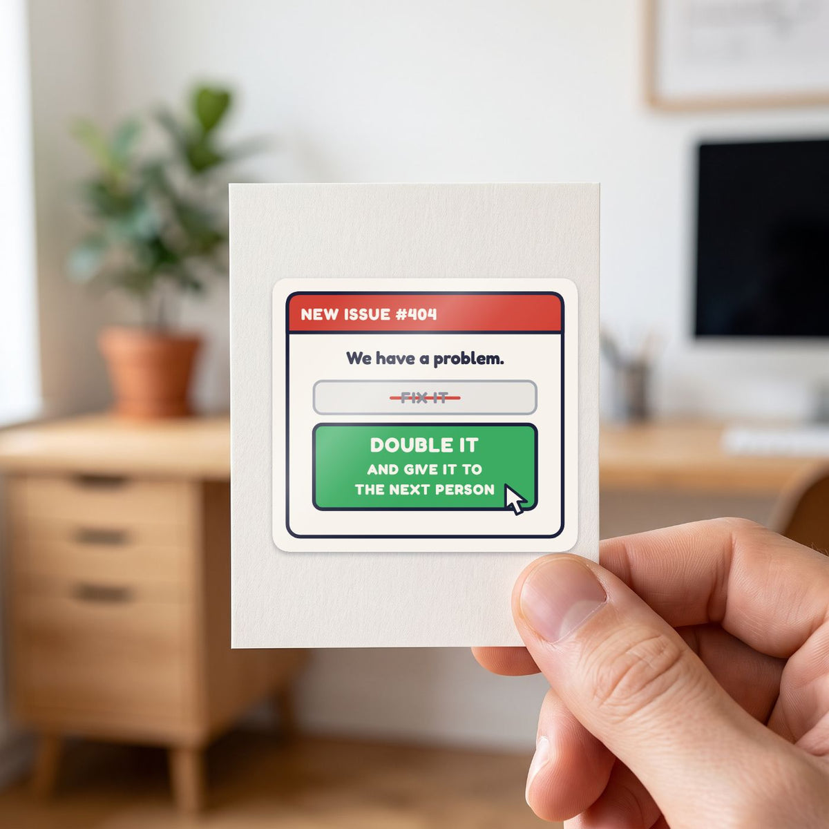 Double It and Give It to the Next Person sticker held in a hand on its white backing card