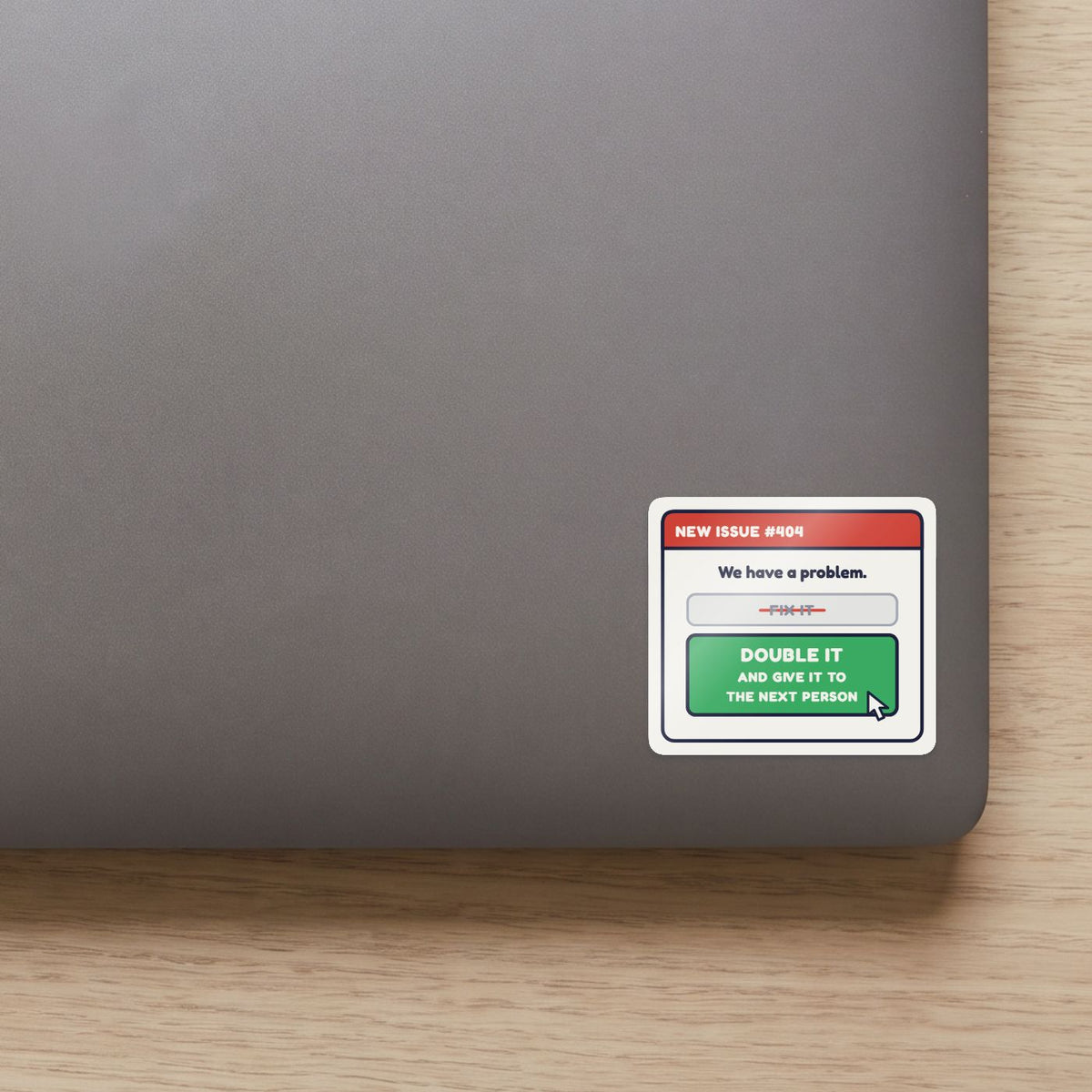 Double It and Give It to the Next Person sticker on the lid of a grey laptop