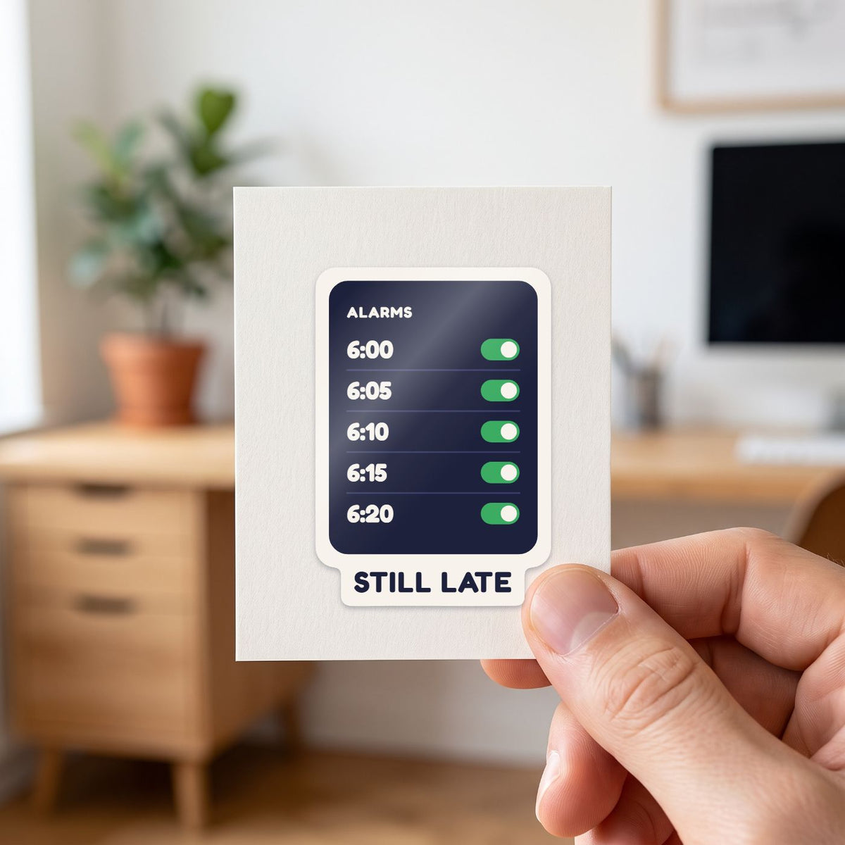 Five Alarms, Still Late sticker held in a hand on its white backing card