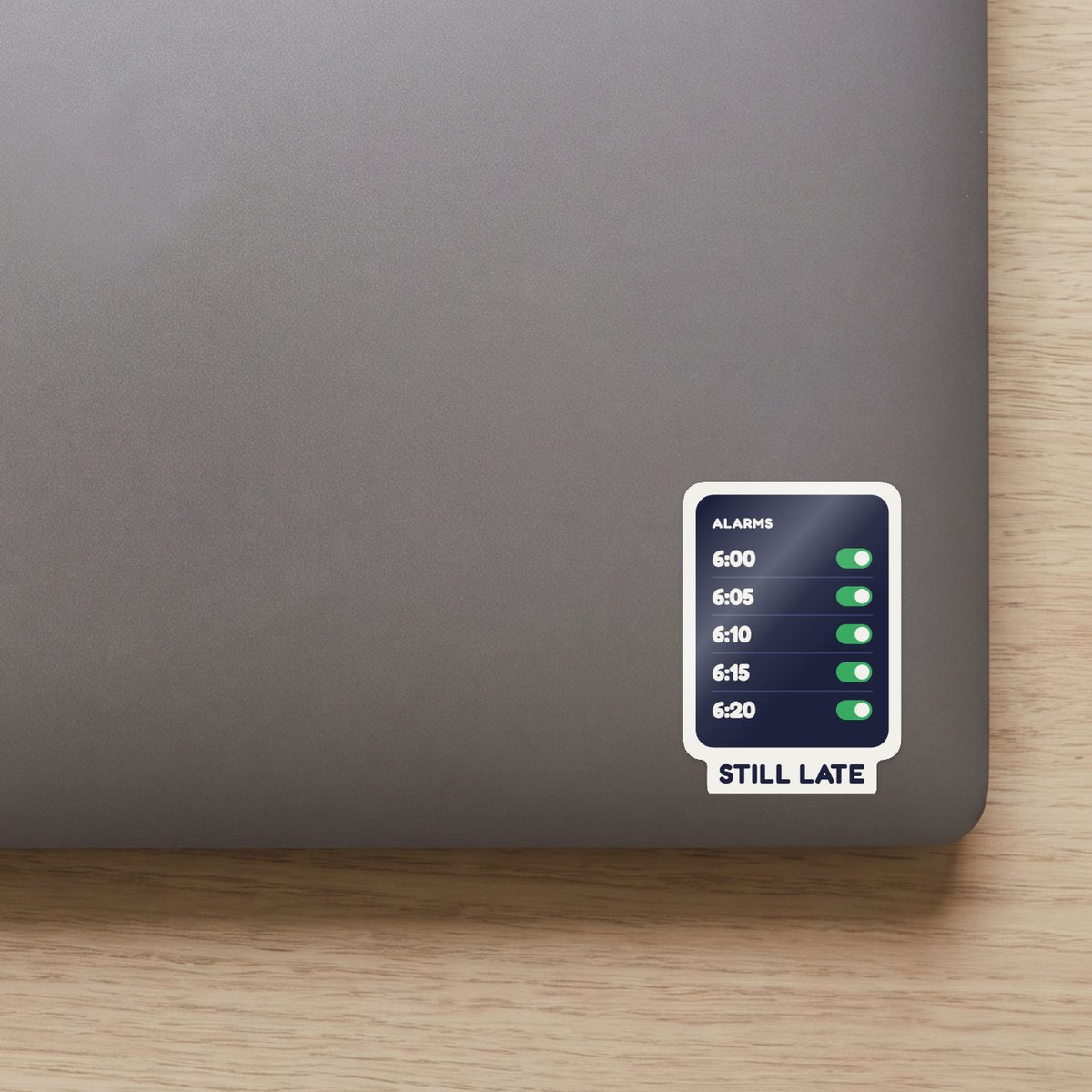 Five Alarms, Still Late sticker on the lid of a grey laptop