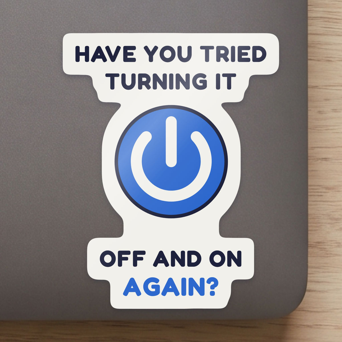 Have You Tried Turning It Off and On Again? sticker close up on a laptop lid, showing the gloss and the white cut edge