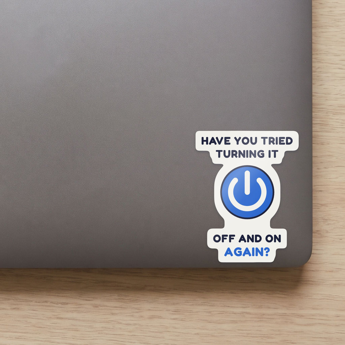 Have You Tried Turning It Off and On Again? sticker on the lid of a grey laptop