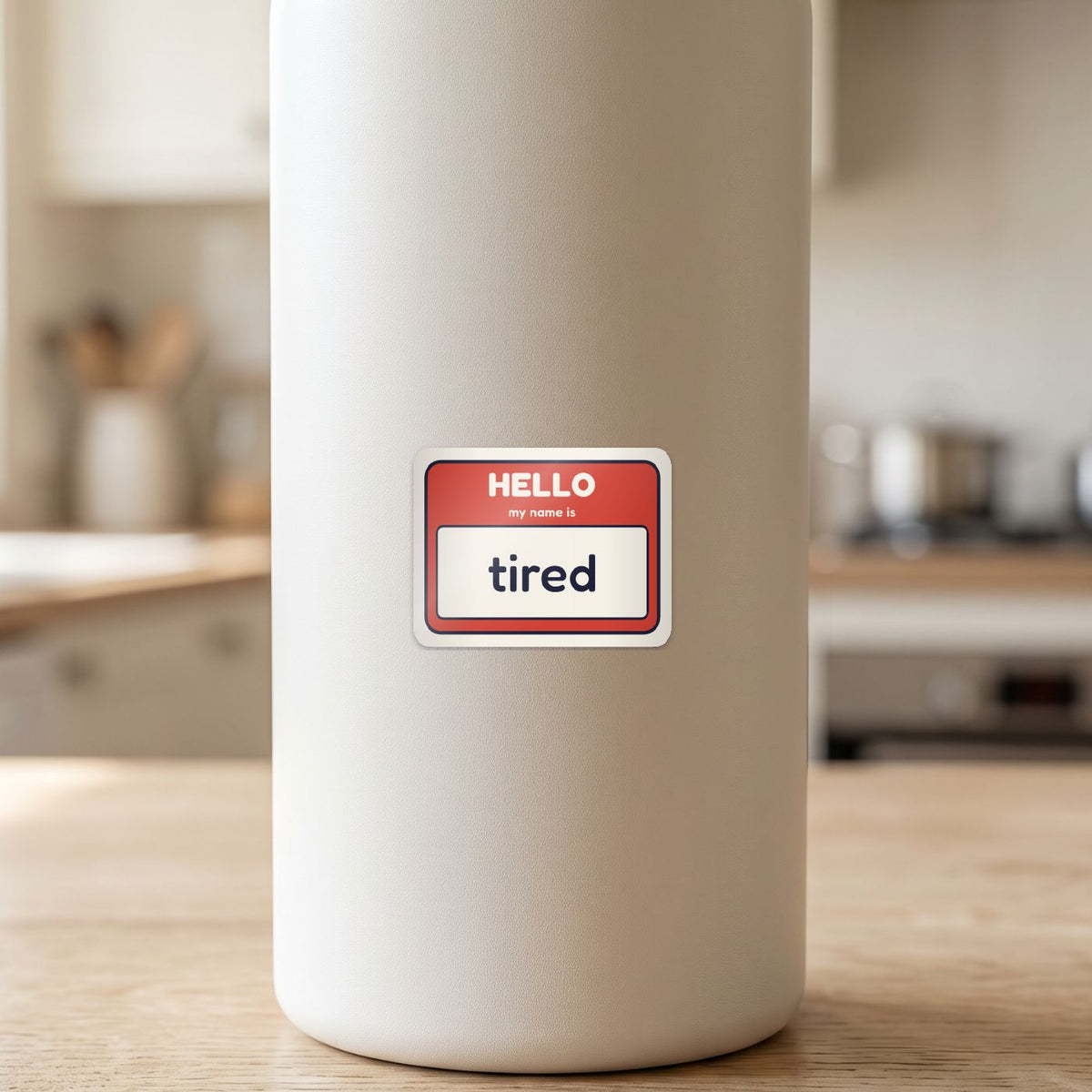 Hello, My Name Is Tired sticker on a white drink bottle