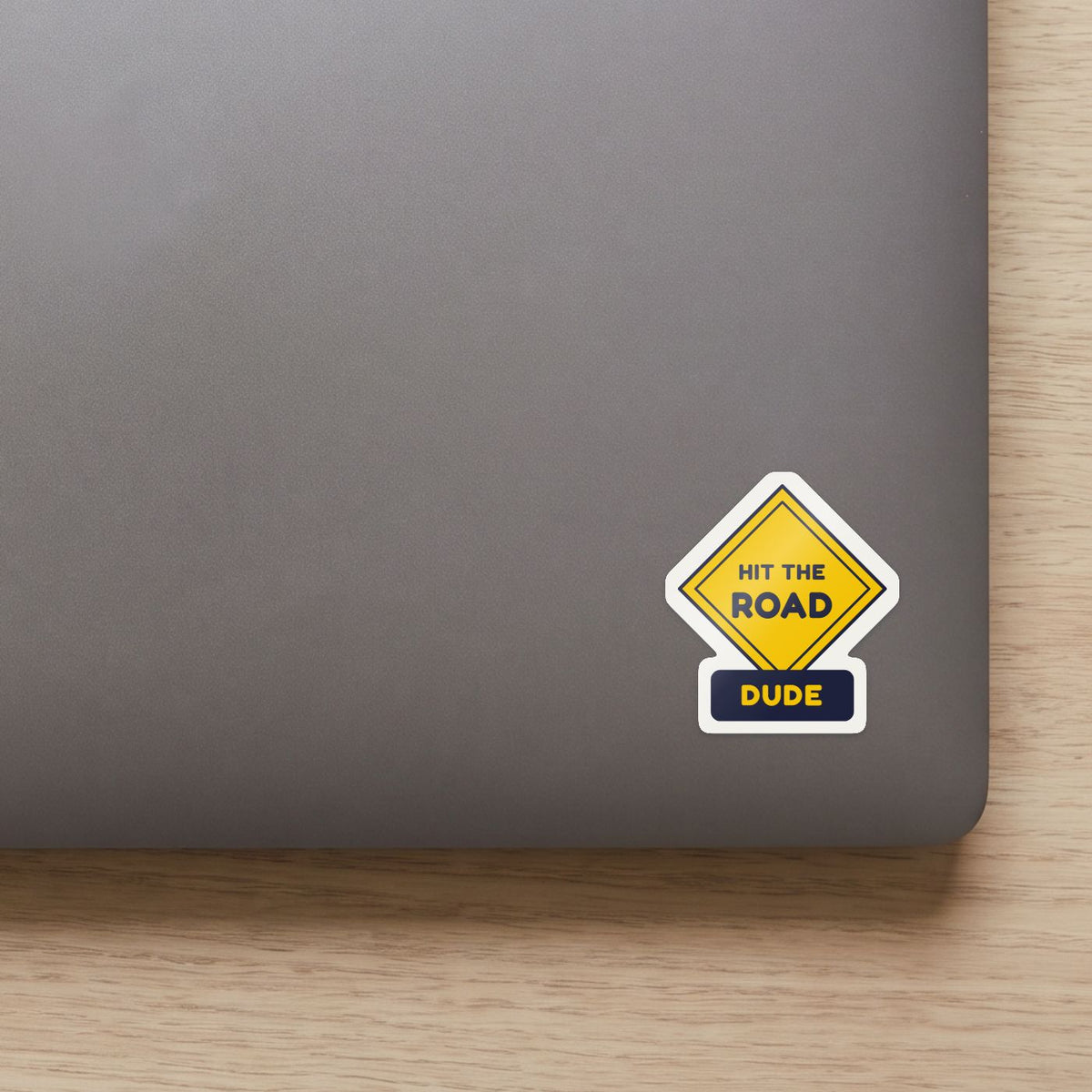 Hit the Road, Dude (Road Sign) sticker on the lid of a grey laptop
