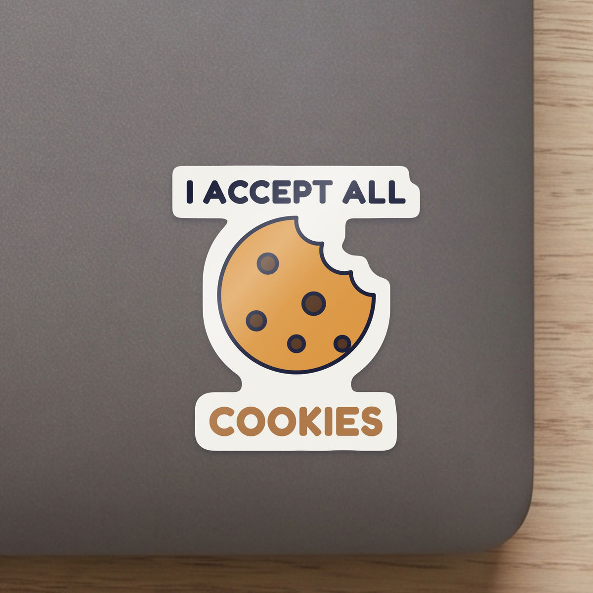 I Accept All Cookies sticker close up on a laptop lid, showing the gloss and the white cut edge