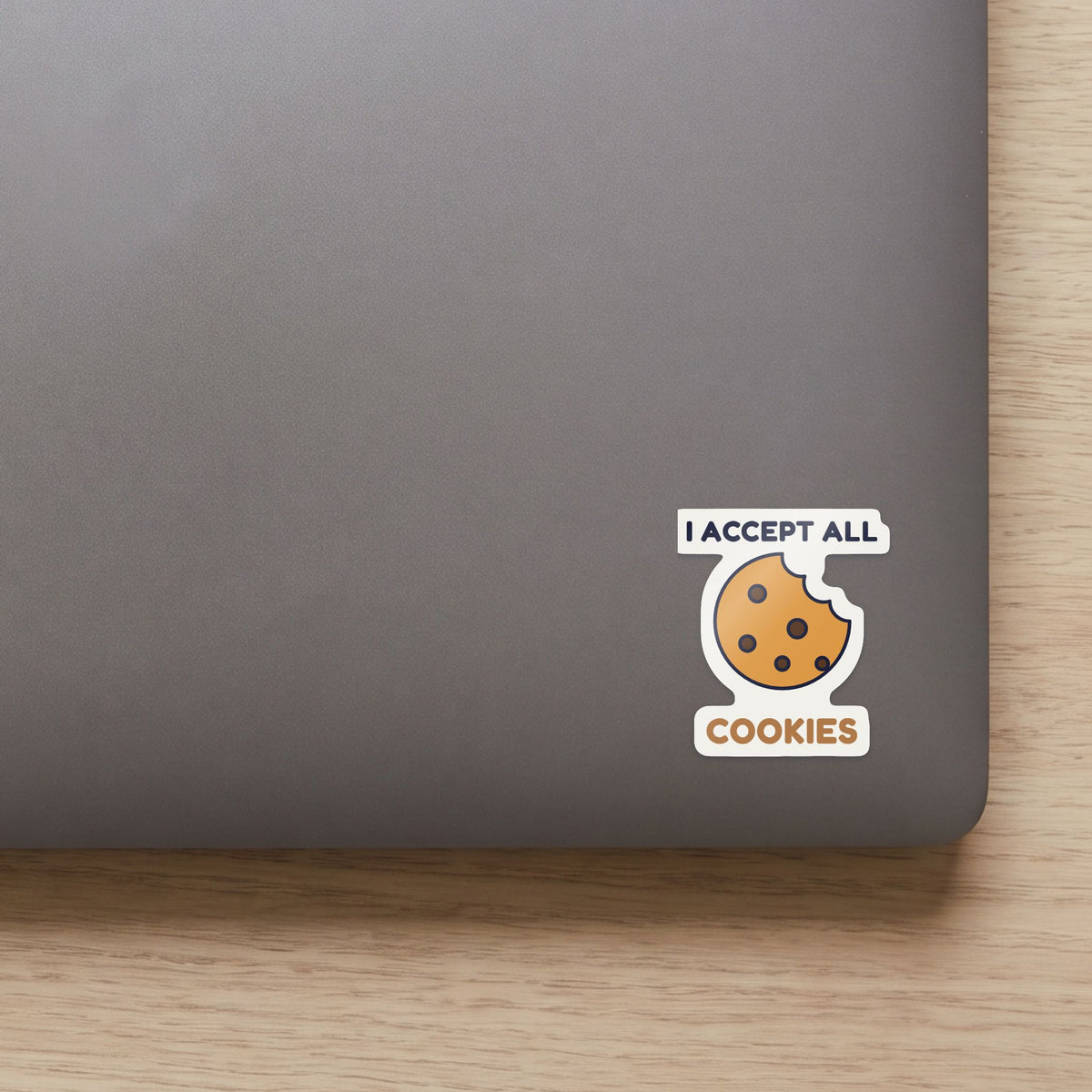 I Accept All Cookies sticker on the lid of a grey laptop