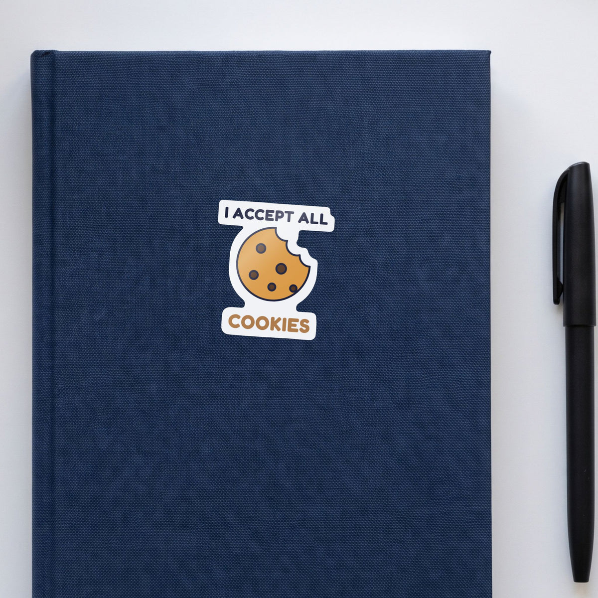 I Accept All Cookies sticker on a navy notebook