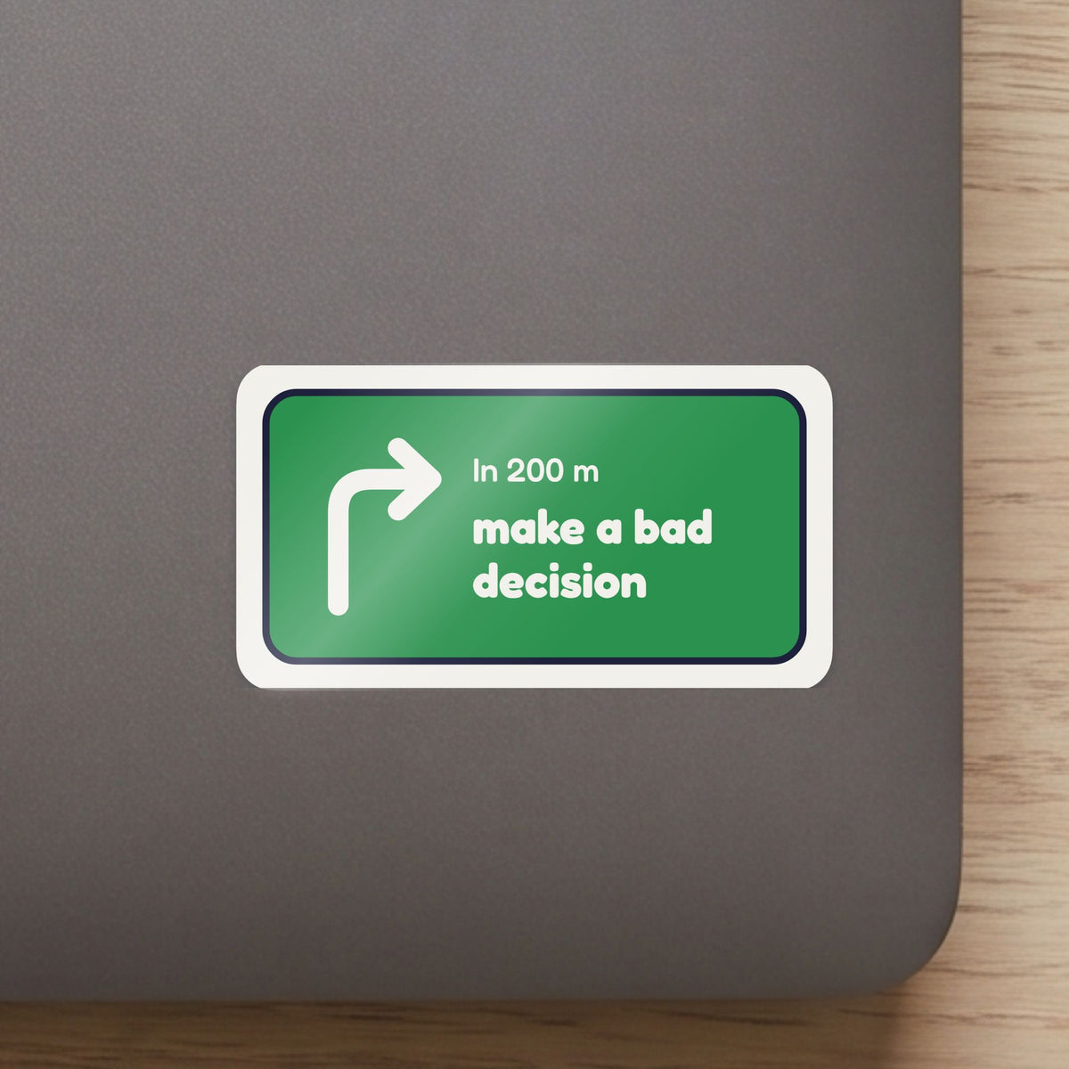In 200 m, Make a Bad Decision sticker on the lid of a grey laptop