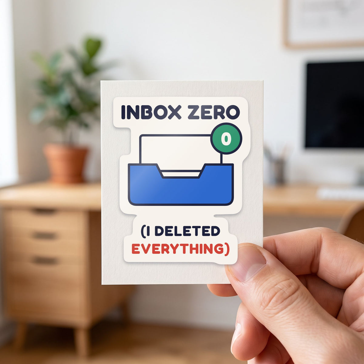 Inbox Zero (I Deleted Everything) sticker held in a hand on its white backing card