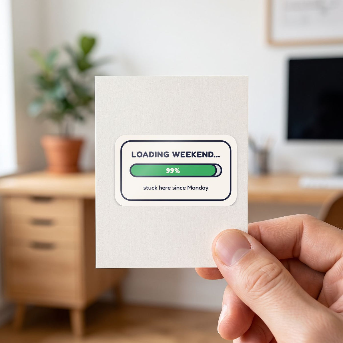 Loading Weekend... 99% sticker held in a hand on its white backing card