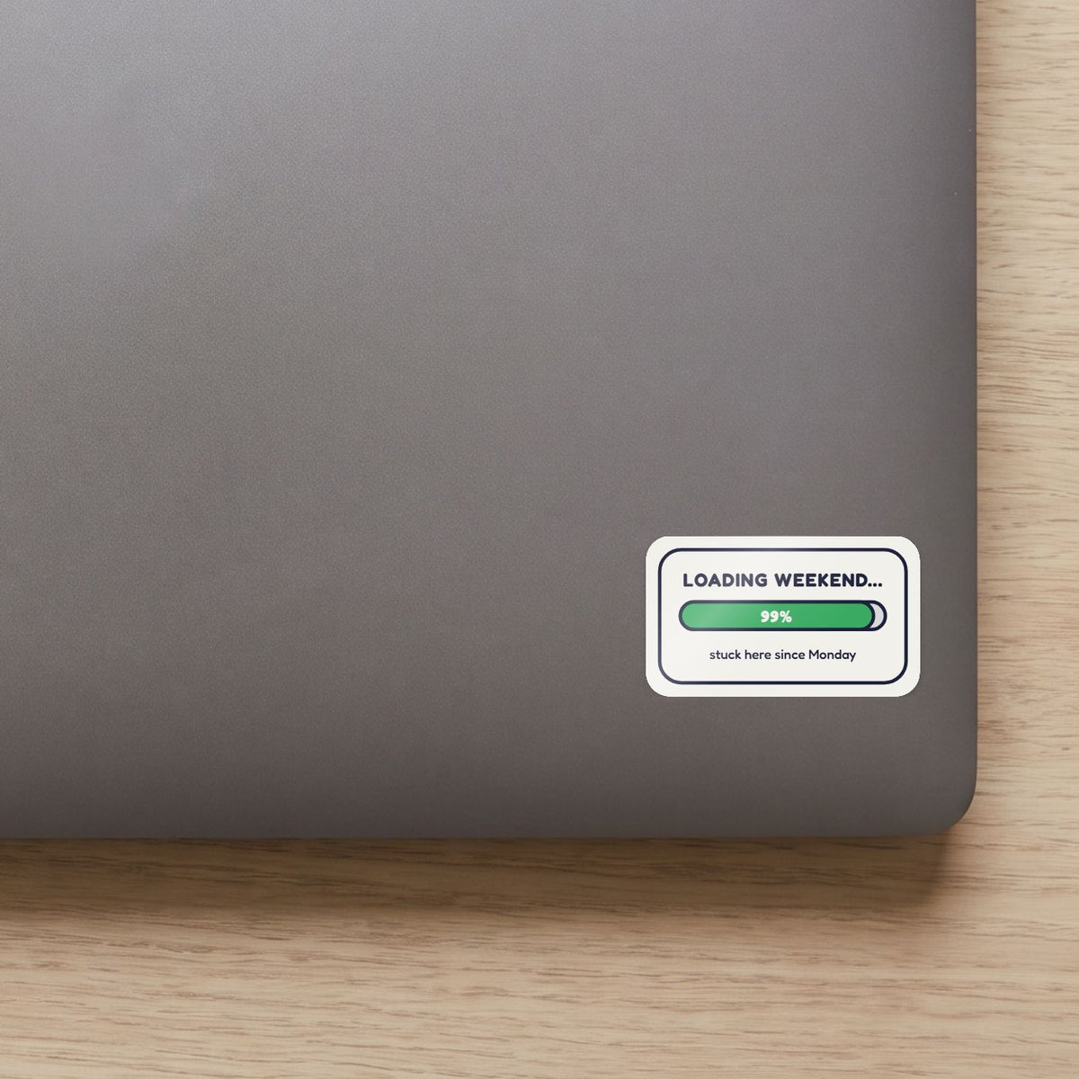 Loading Weekend... 99% sticker on the lid of a grey laptop