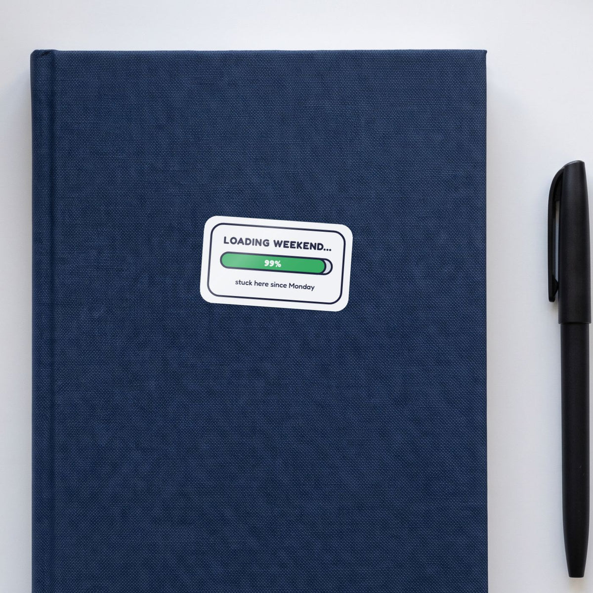 Loading Weekend... 99% sticker on a navy notebook