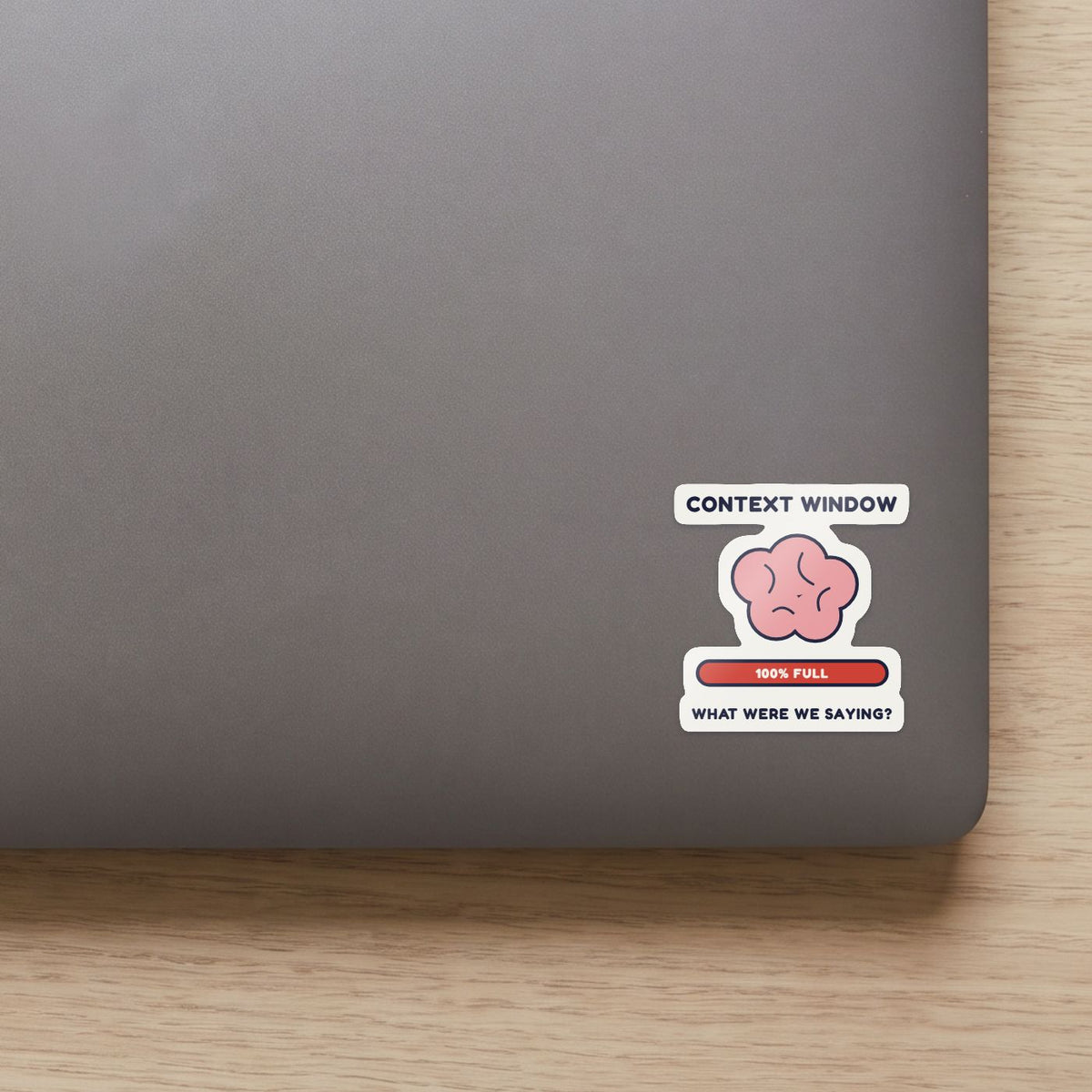 My Context Window Is Full sticker on the lid of a grey laptop