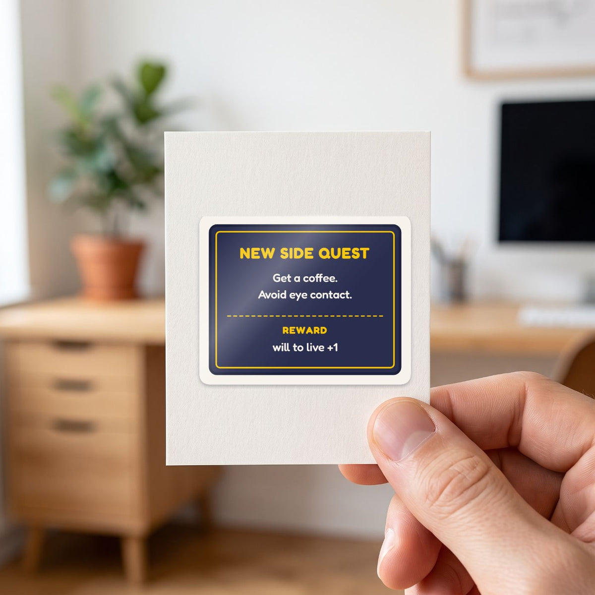 New Side Quest sticker held in a hand on its white backing card