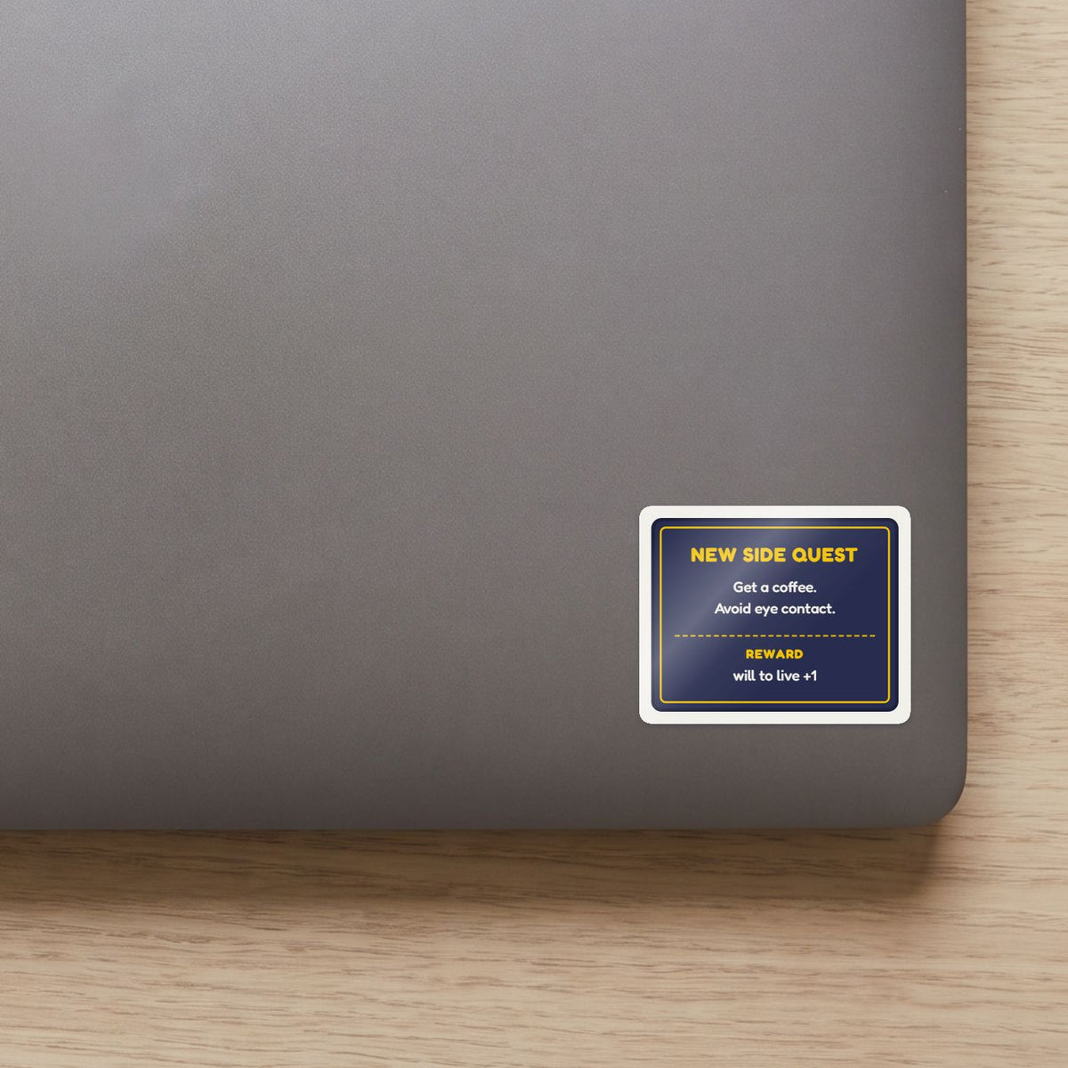 New Side Quest sticker on the lid of a grey laptop