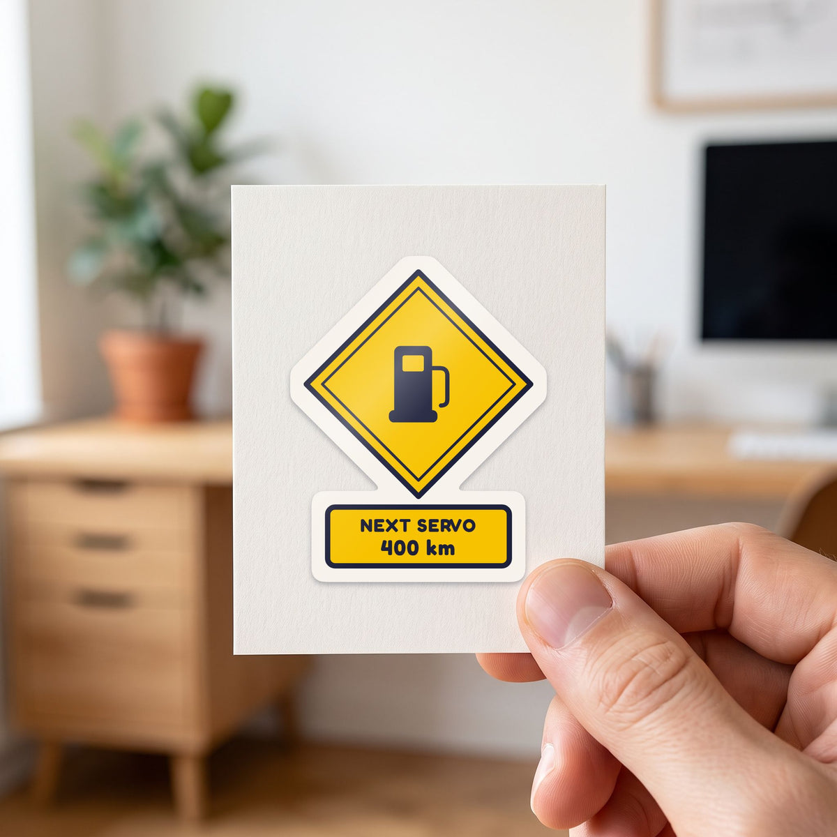 Next Servo 400 km sticker held in a hand on its white backing card