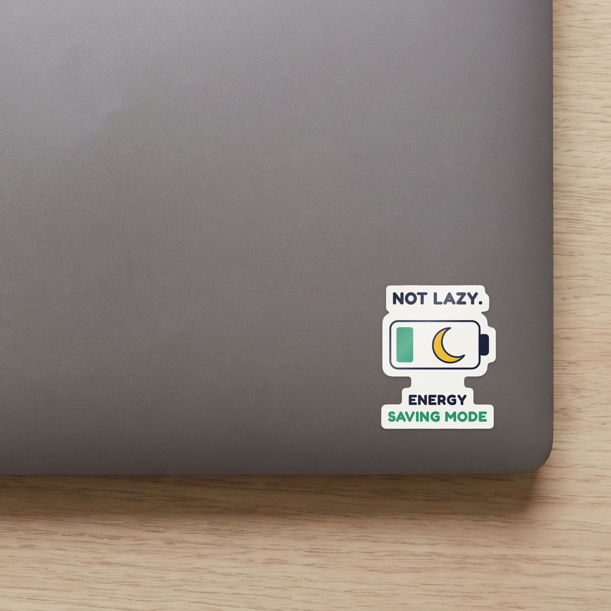 Not Lazy. Energy Saving Mode. sticker on the lid of a grey laptop