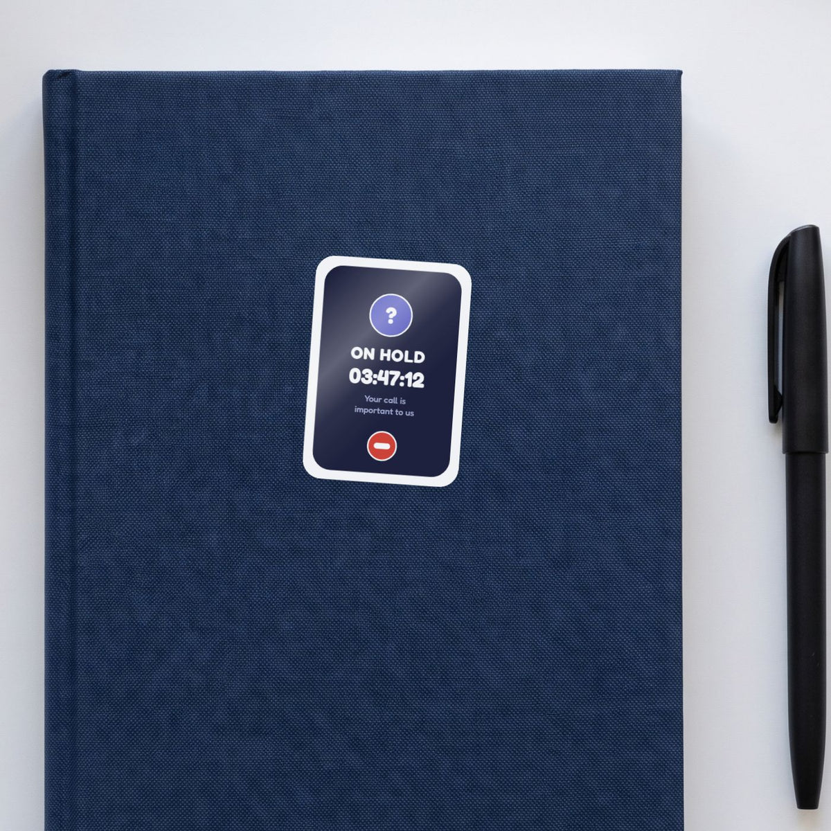 On Hold: 03:47:12 sticker on a navy notebook