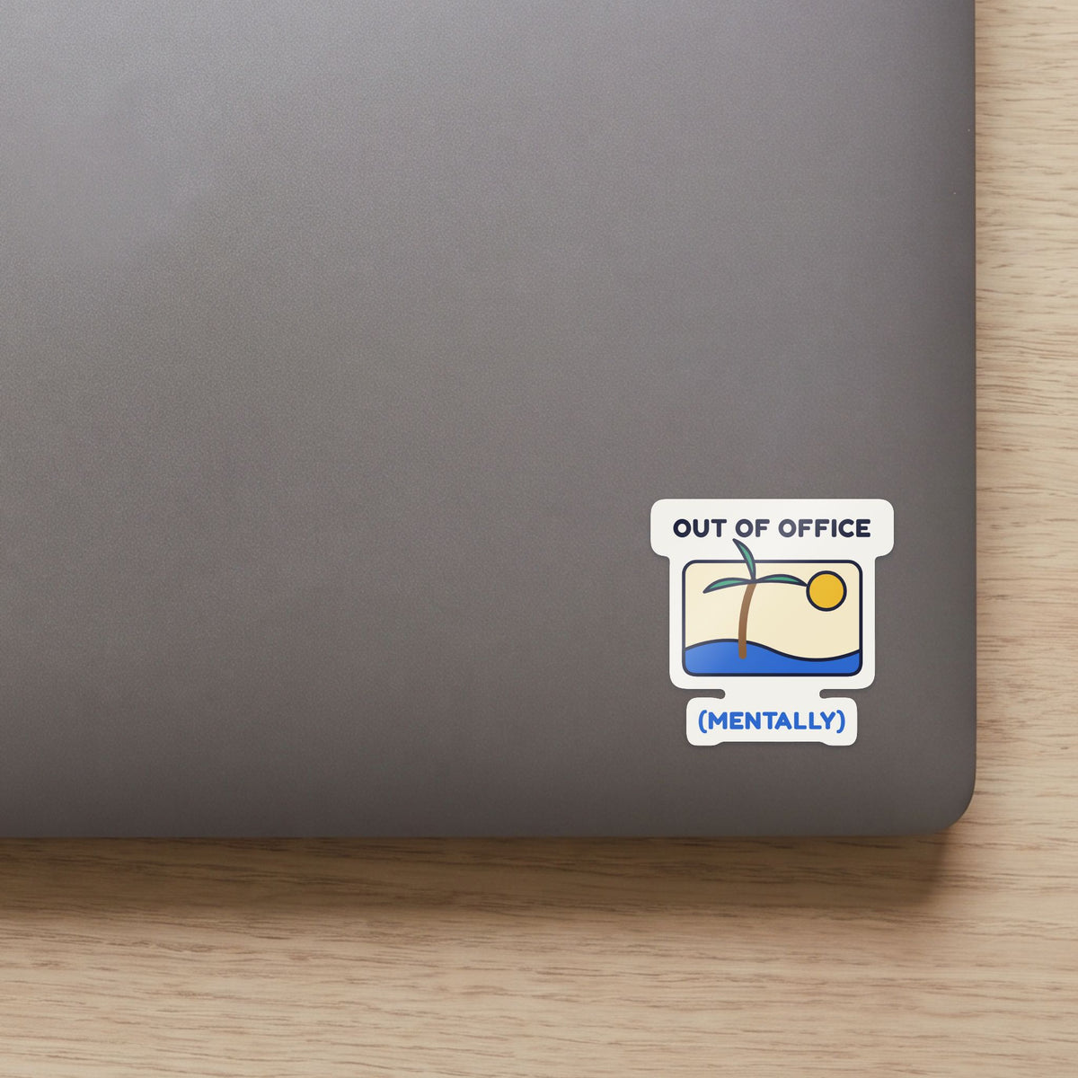 Out of Office (Mentally) sticker on the lid of a grey laptop