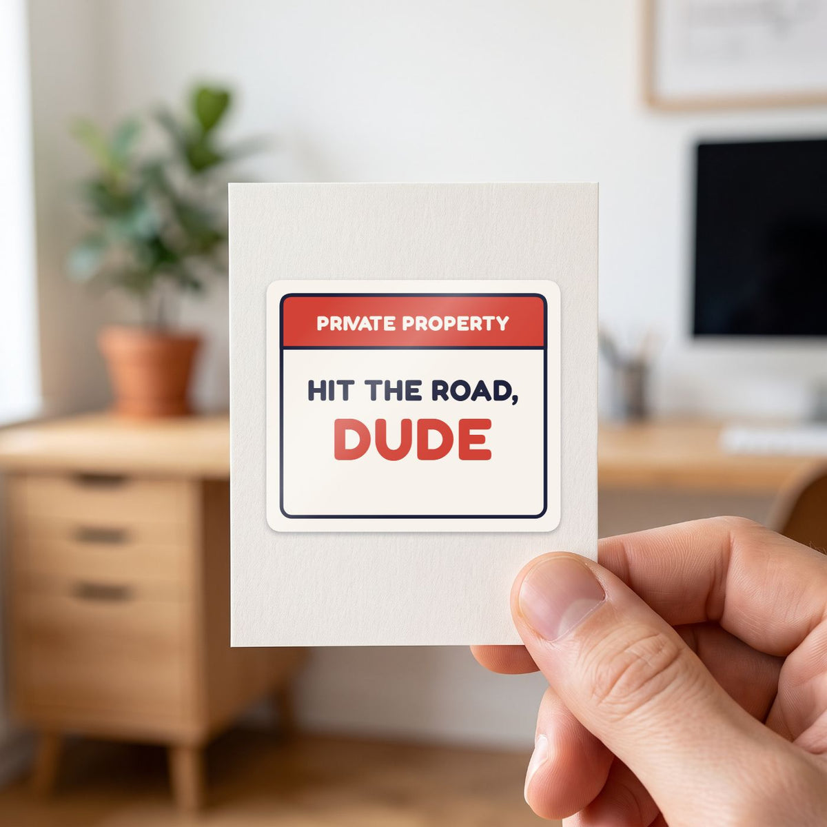 Private Property: Hit the Road, Dude sticker held in a hand on its white backing card