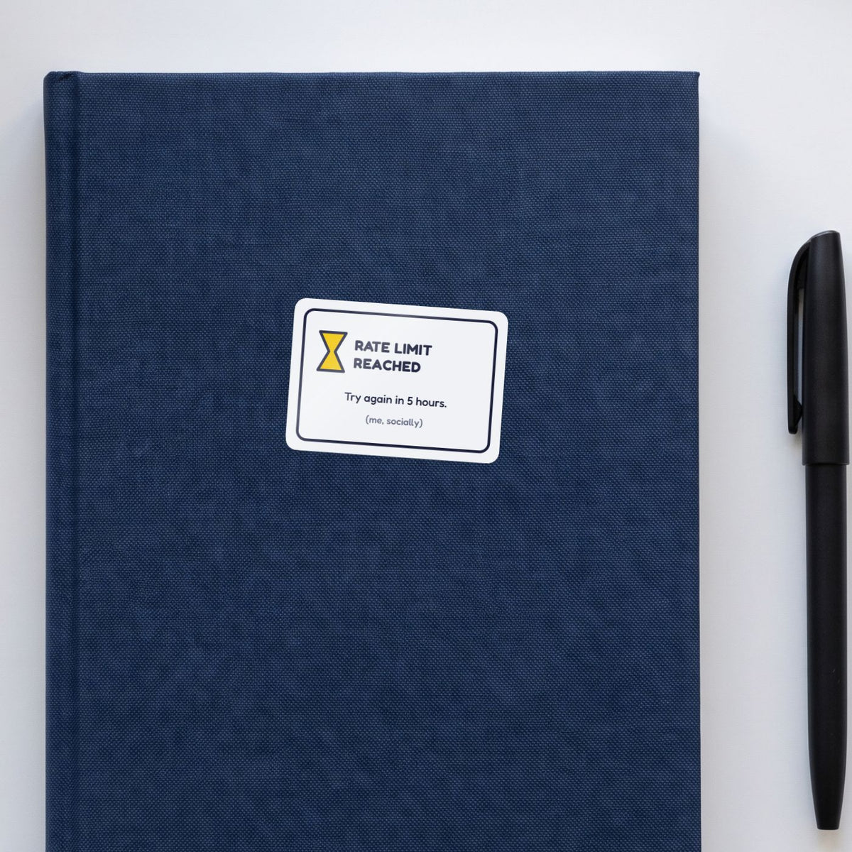 Rate Limit Reached sticker on a navy notebook