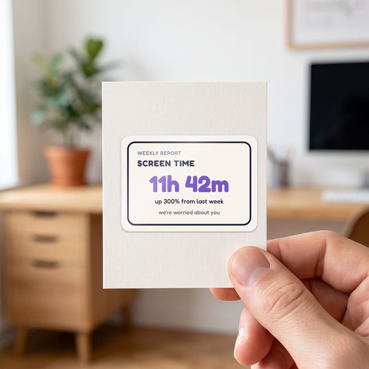 Screen Time: 11h 42m sticker held in a hand on its white backing card