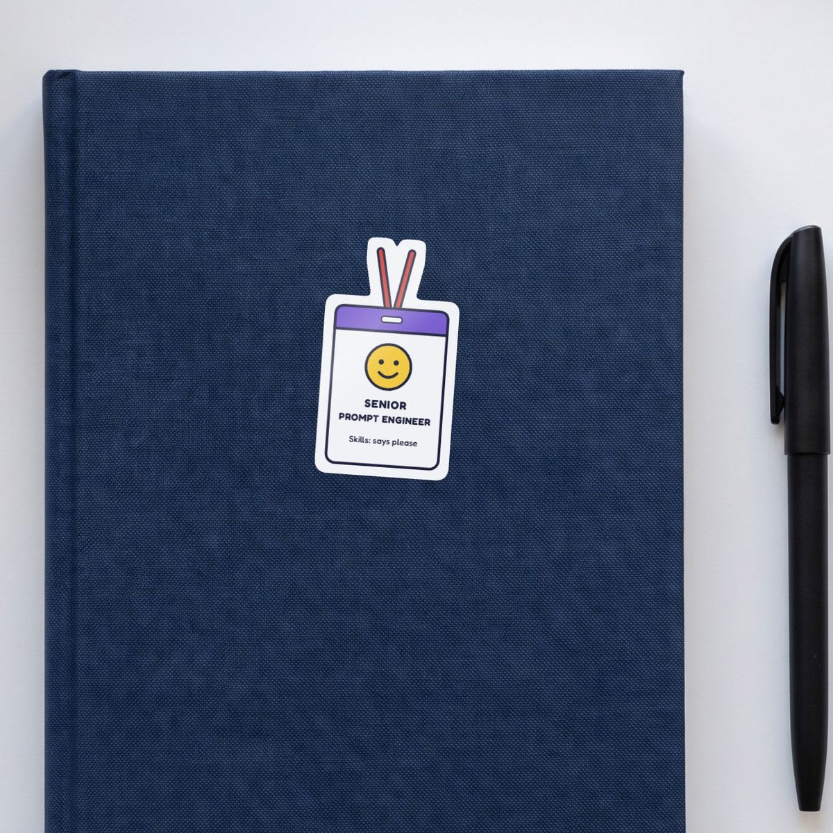 Senior Prompt Engineer sticker on a navy notebook