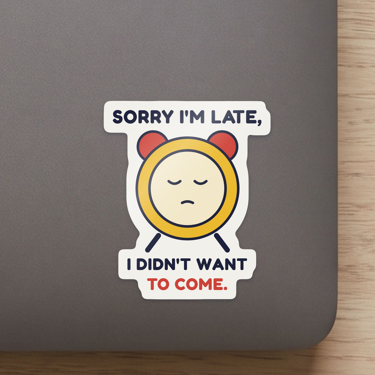 Sorry I'm Late, I Didn't Want to Come sticker close up on a laptop lid, showing the gloss and the white cut edge