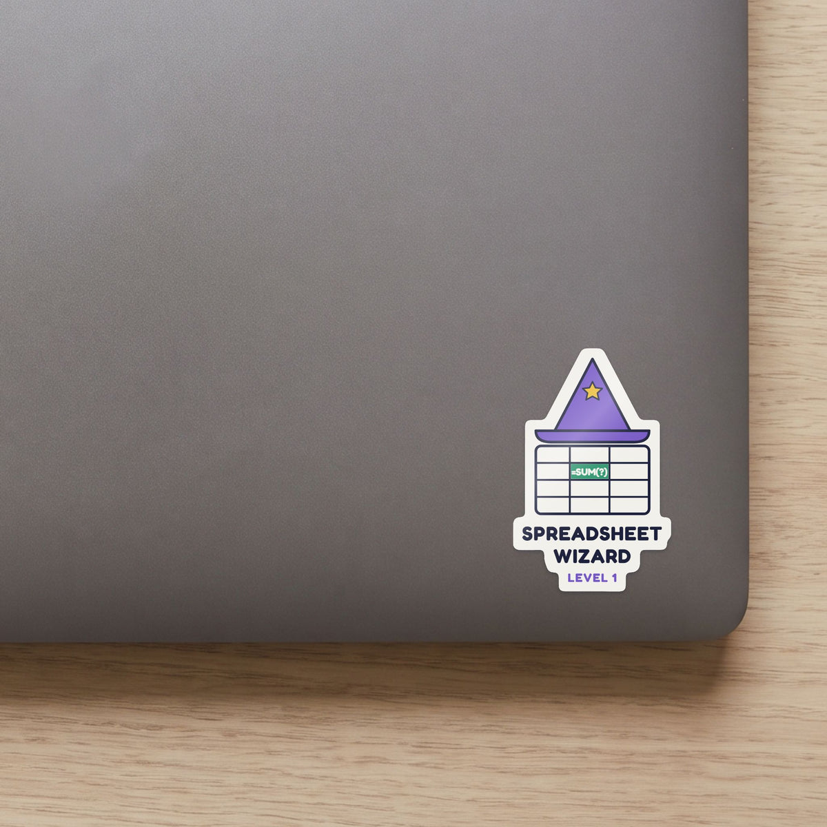 Spreadsheet Wizard, Level 1 sticker on the lid of a grey laptop