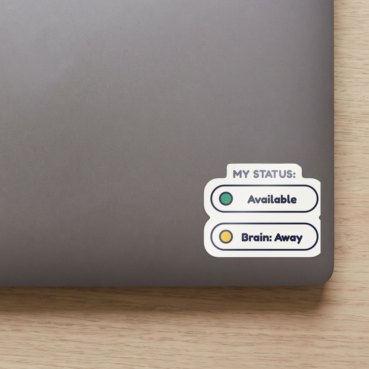 Status: Available. Brain: Away. sticker on the lid of a grey laptop