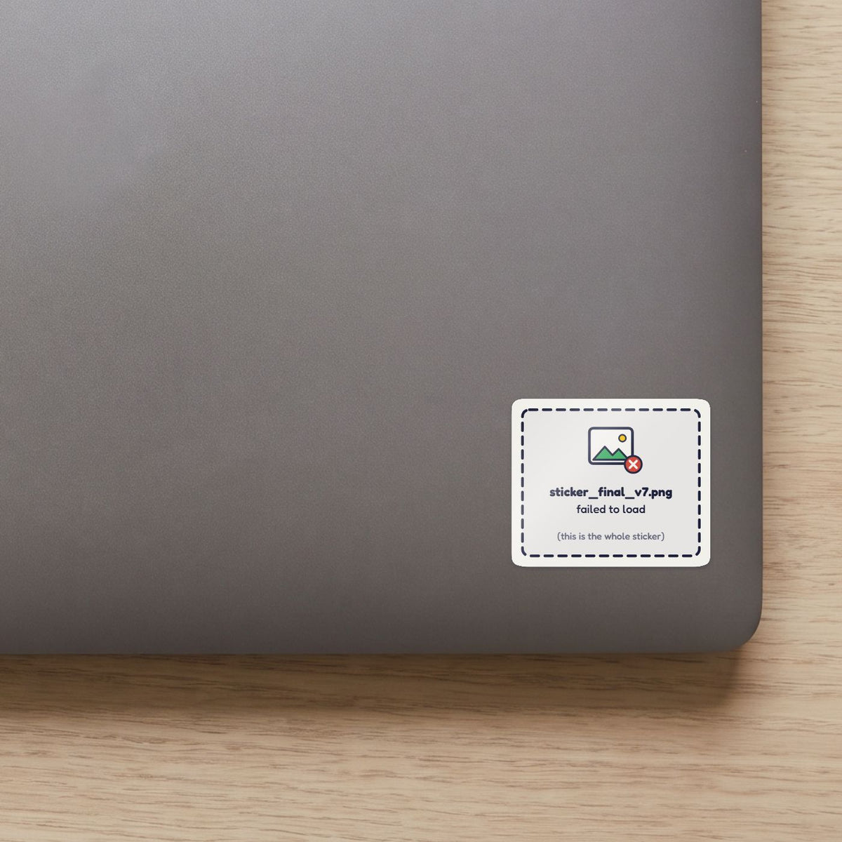 Sticker Failed to Load sticker on the lid of a grey laptop