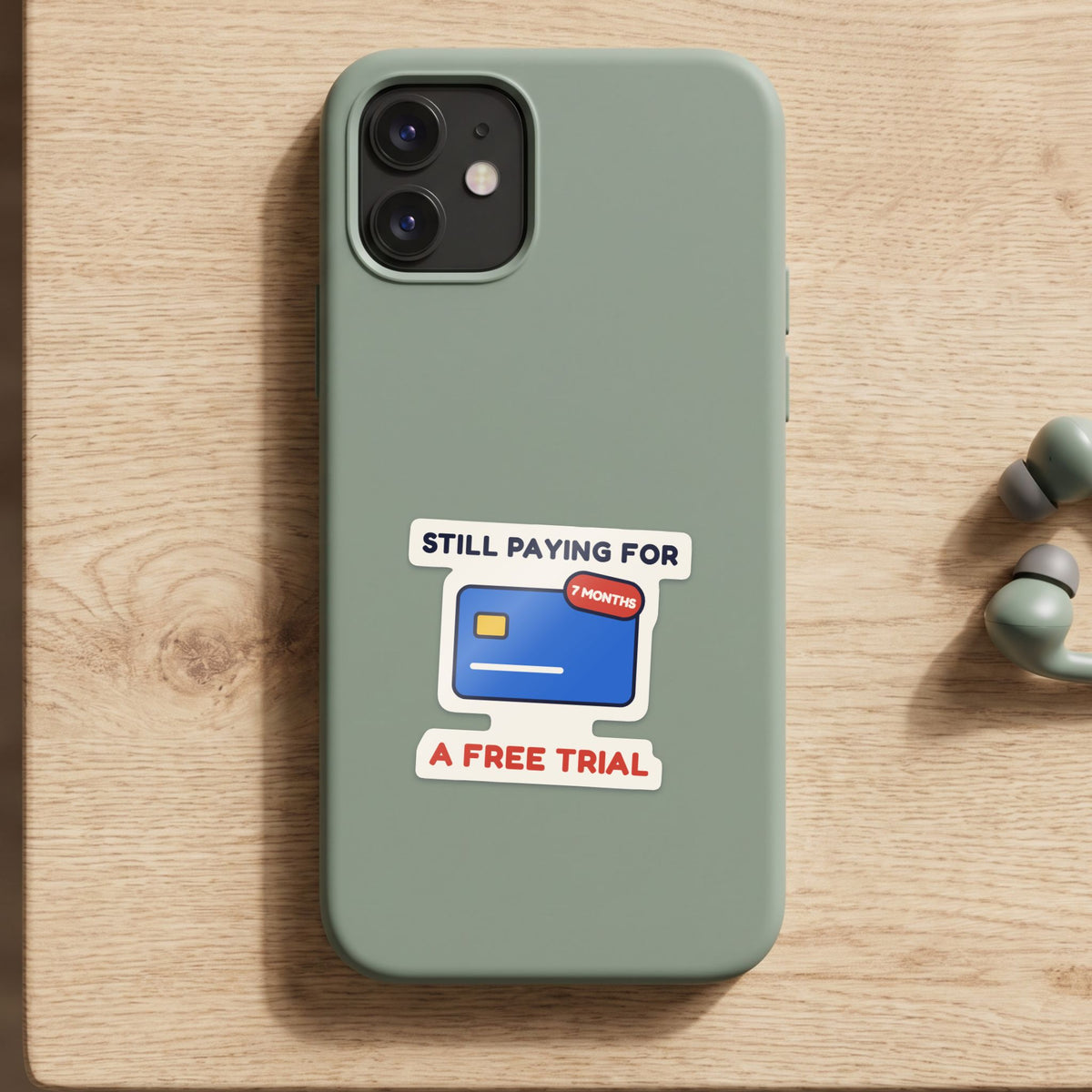 Still Paying for a Free Trial sticker on a green phone case