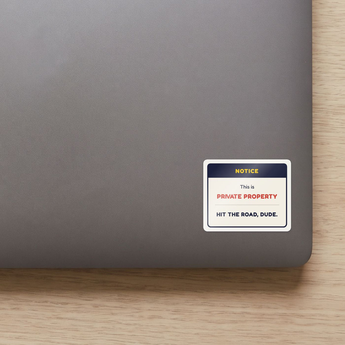 This Is Private Property sticker on the lid of a grey laptop