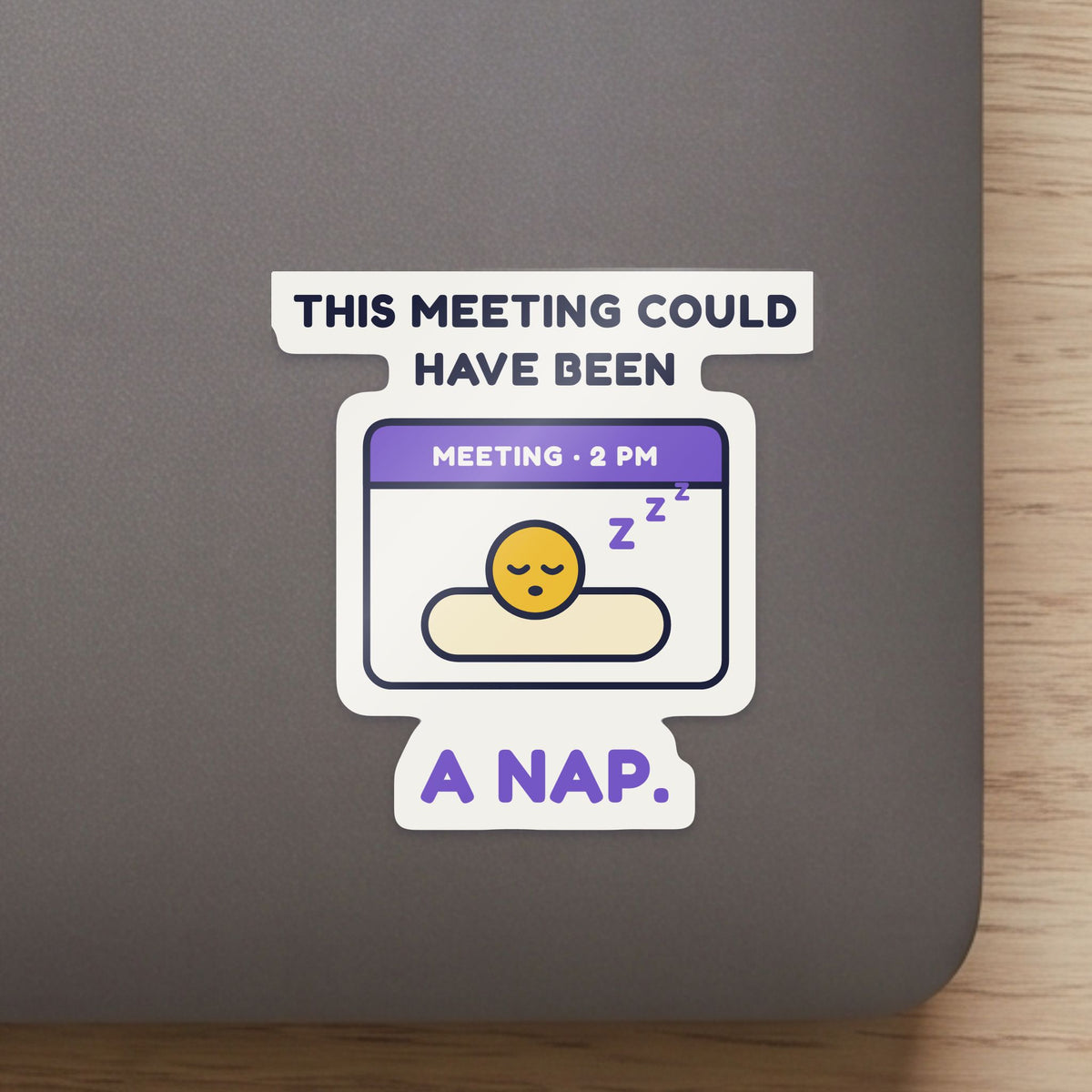 This Meeting Could Have Been a Nap sticker close up on a laptop lid, showing the gloss and the white cut edge