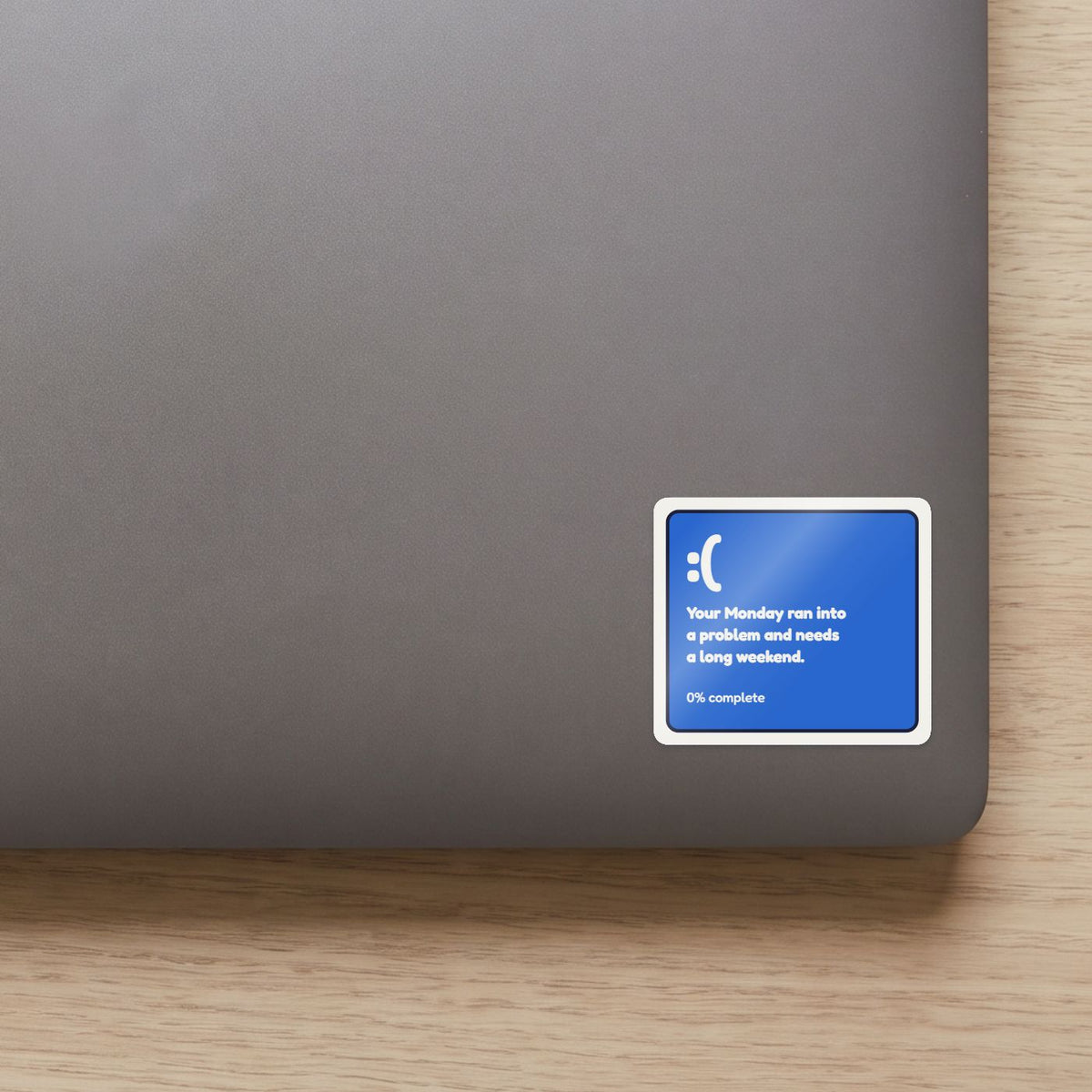 Your Monday Ran Into a Problem sticker on the lid of a grey laptop