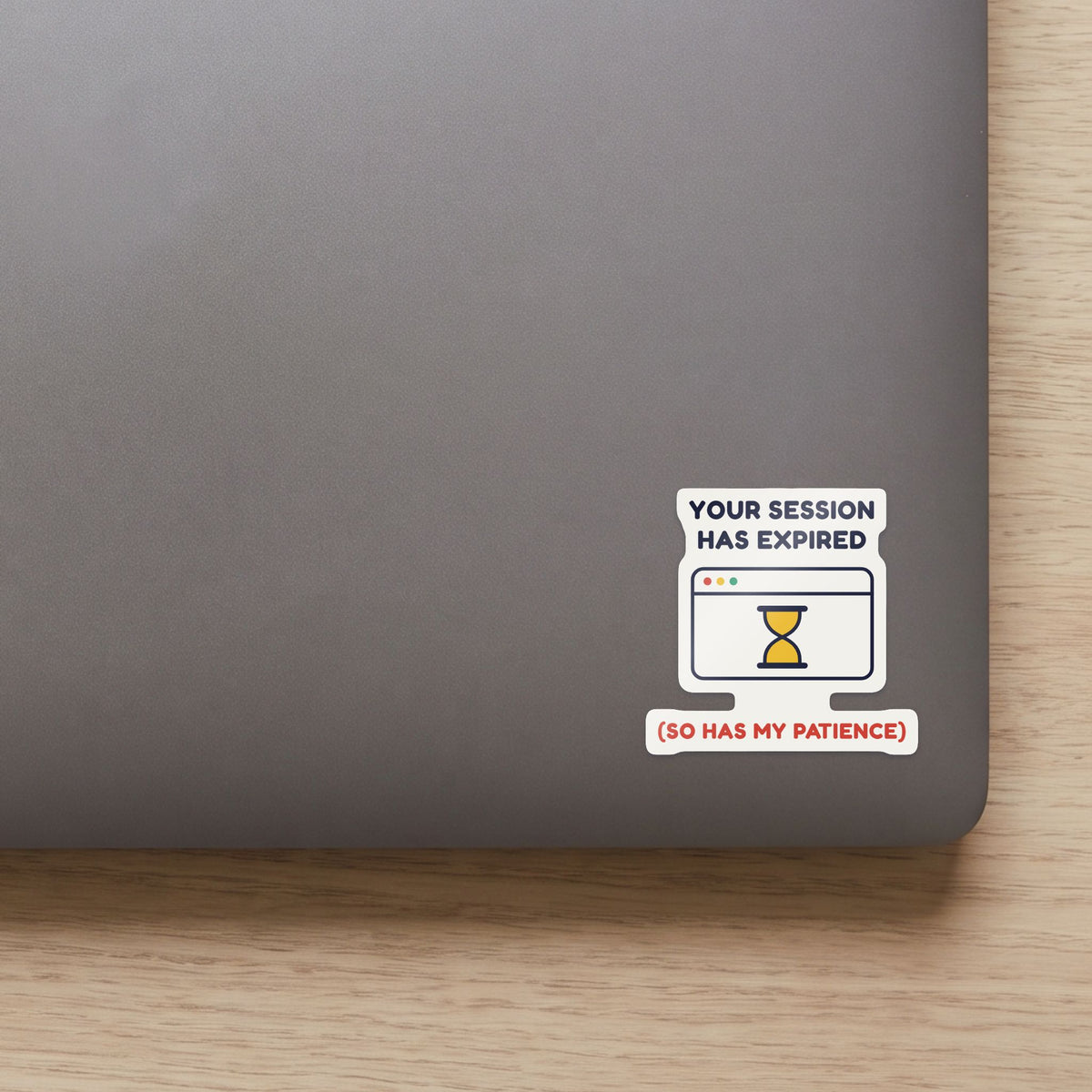 Your Session Has Expired sticker on the lid of a grey laptop