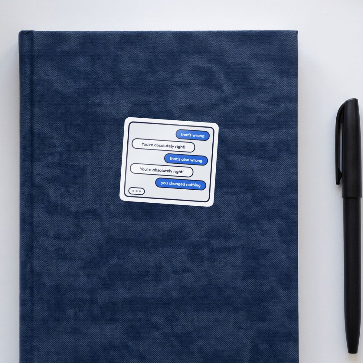 You're Absolutely Right! sticker on a navy notebook