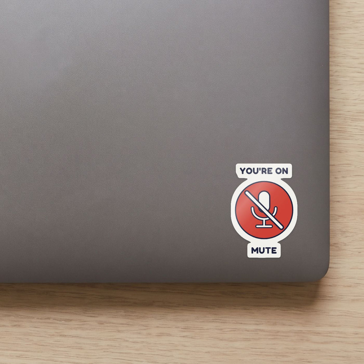 You're on Mute sticker on the lid of a grey laptop